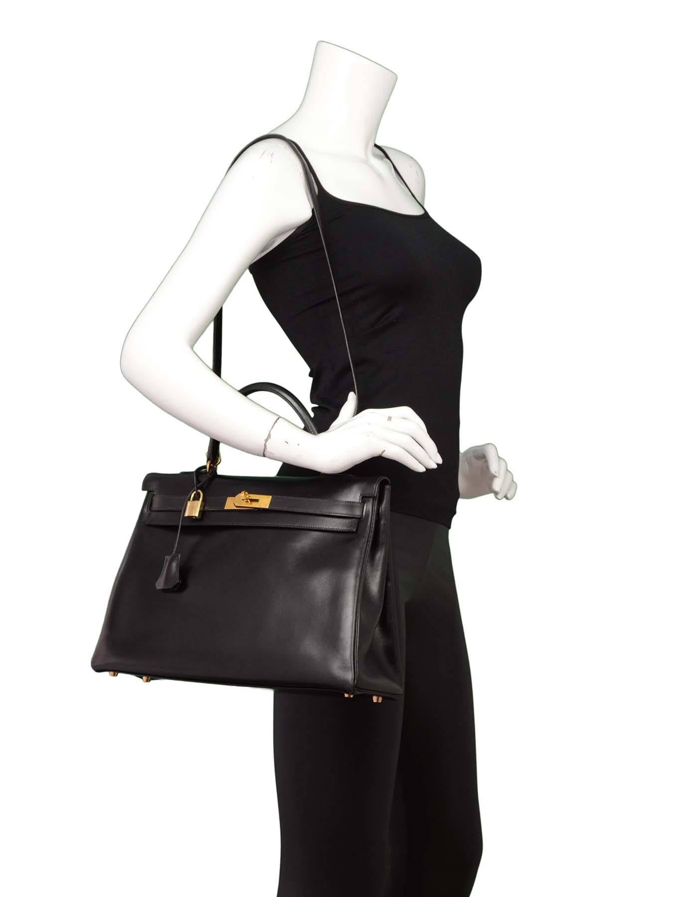 Hermes Vintage Black 35cm Kelly Retourne Bag
Features removable shoulder/crossbody strap

Made in: France
Year of Production: 1995
Color: Black
Hardware: Golstone
Materials: Box leather
Lining: Box leather
Closure/opening: Flap top with two