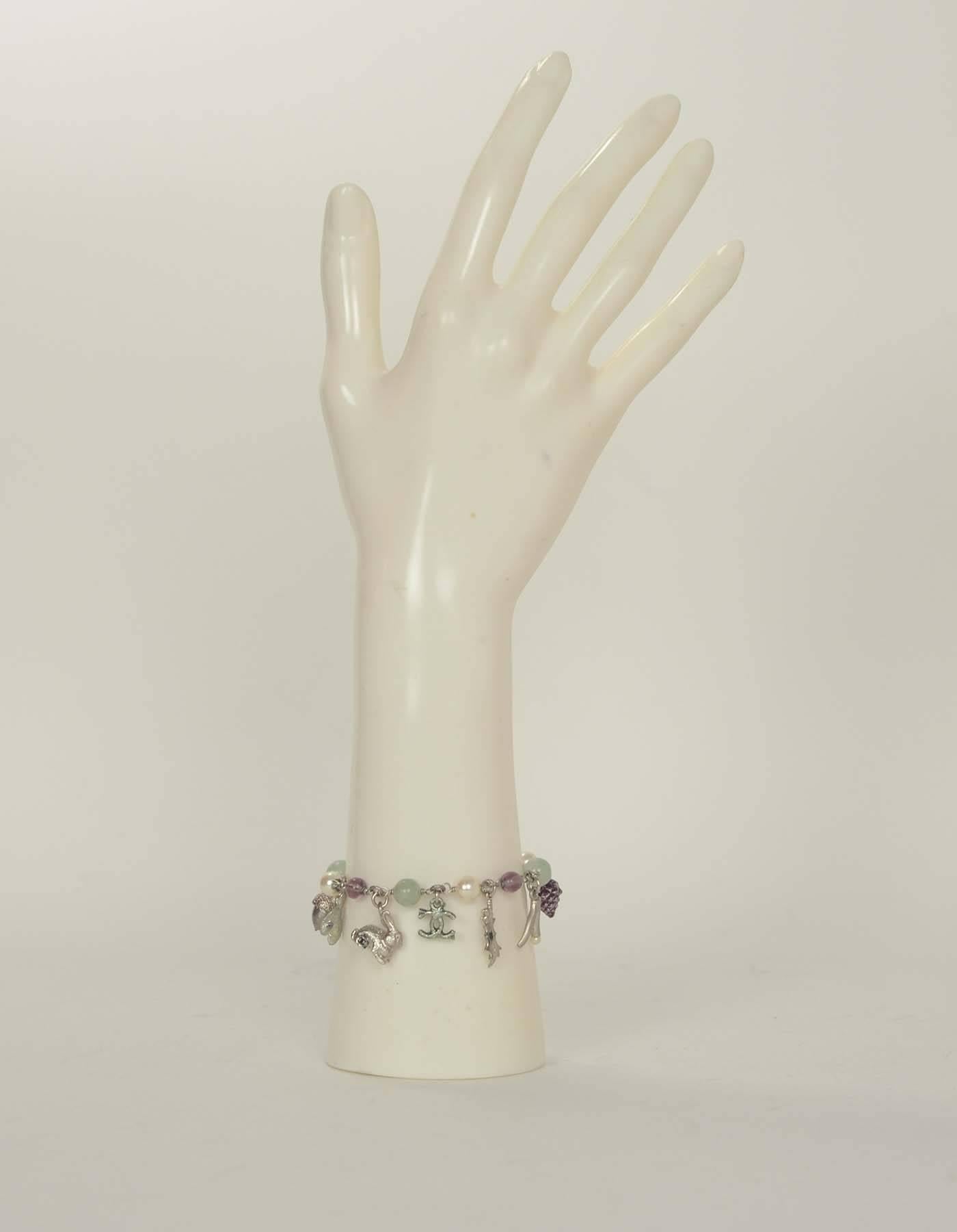 Chanel Multicolored Bracelet with Autumn Charms

Color: Green, purple, silver
Materials: Metal, glass, faux pearls
Closure: Lobster claw closure
Overall Condition: Excellent pre-owned condition with the exception of light marks