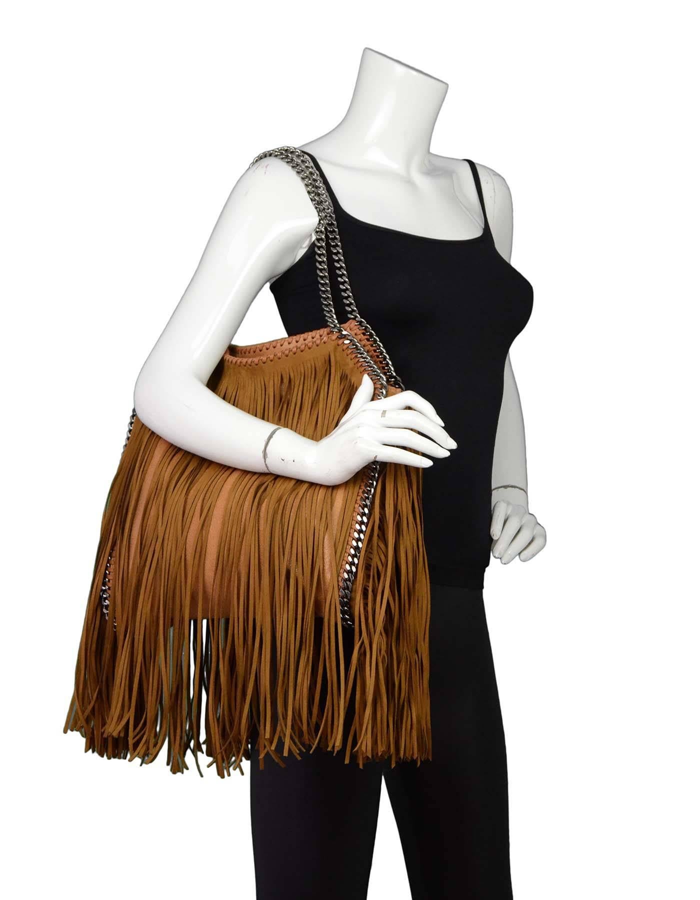 Stella McCartney Tan Fringe Falabella Tote with SHW

Made In: Italy
Color: Tan
Hardware: Gunmetal
Materials: Vegan leather
Lining: Pink textile
Closure/Opening: Open top with single magnetic snap closure
Exterior Pockets: None
Interior
