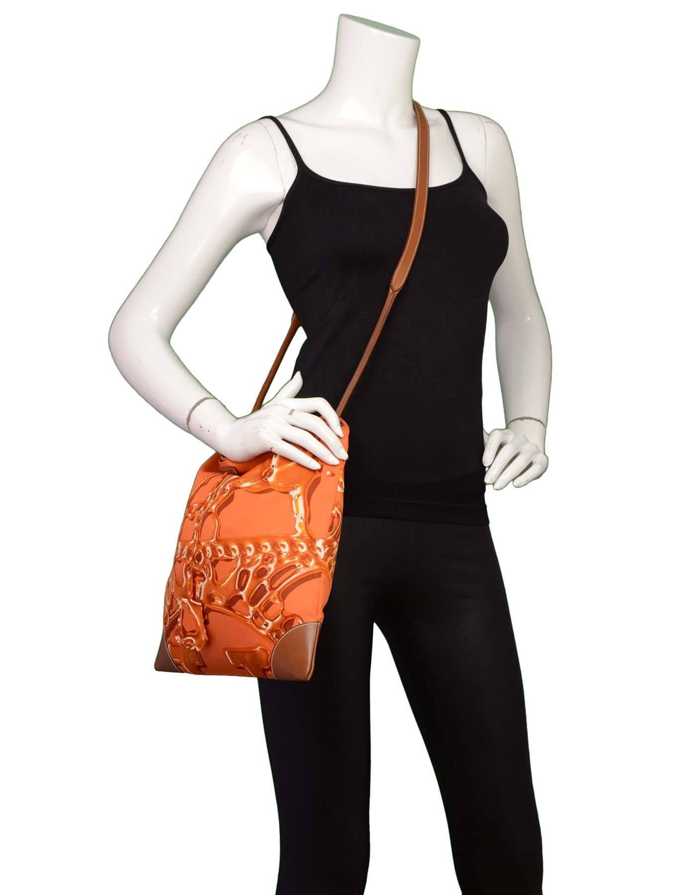 Hermes Orange and Brown Silky City PM Messenger Bag

Features attached zip pouch at interior

Made in: France
Year of Production: 2011
Color: Brown and orange
Hardware: Palladium
Materials: Silk, barenia calfskin
Lining: