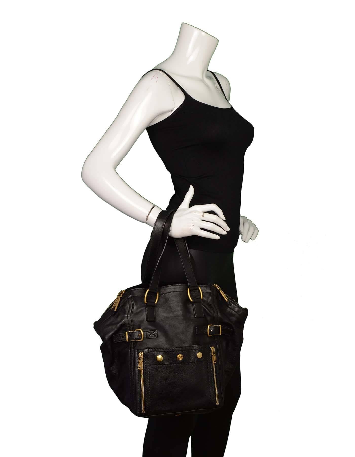 Yves Saint Laurent Black Leather Small Downtown Tote

Made In: Italy
Color: Black
Hardware: Goldtone
Materials: Leather and metal
Lining: Black textile
Closure/Opening: Zip closure at sides and open in middle
Exterior Pockets: One front