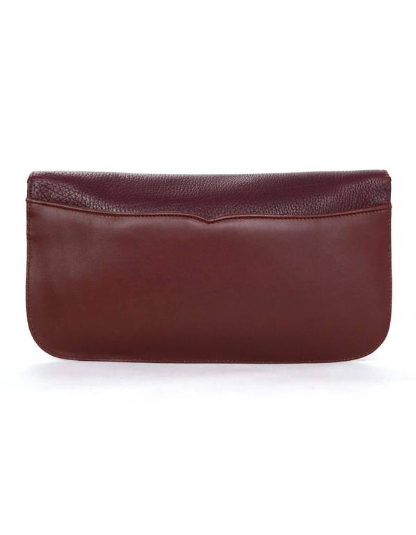 burgundy and gold clutch bag