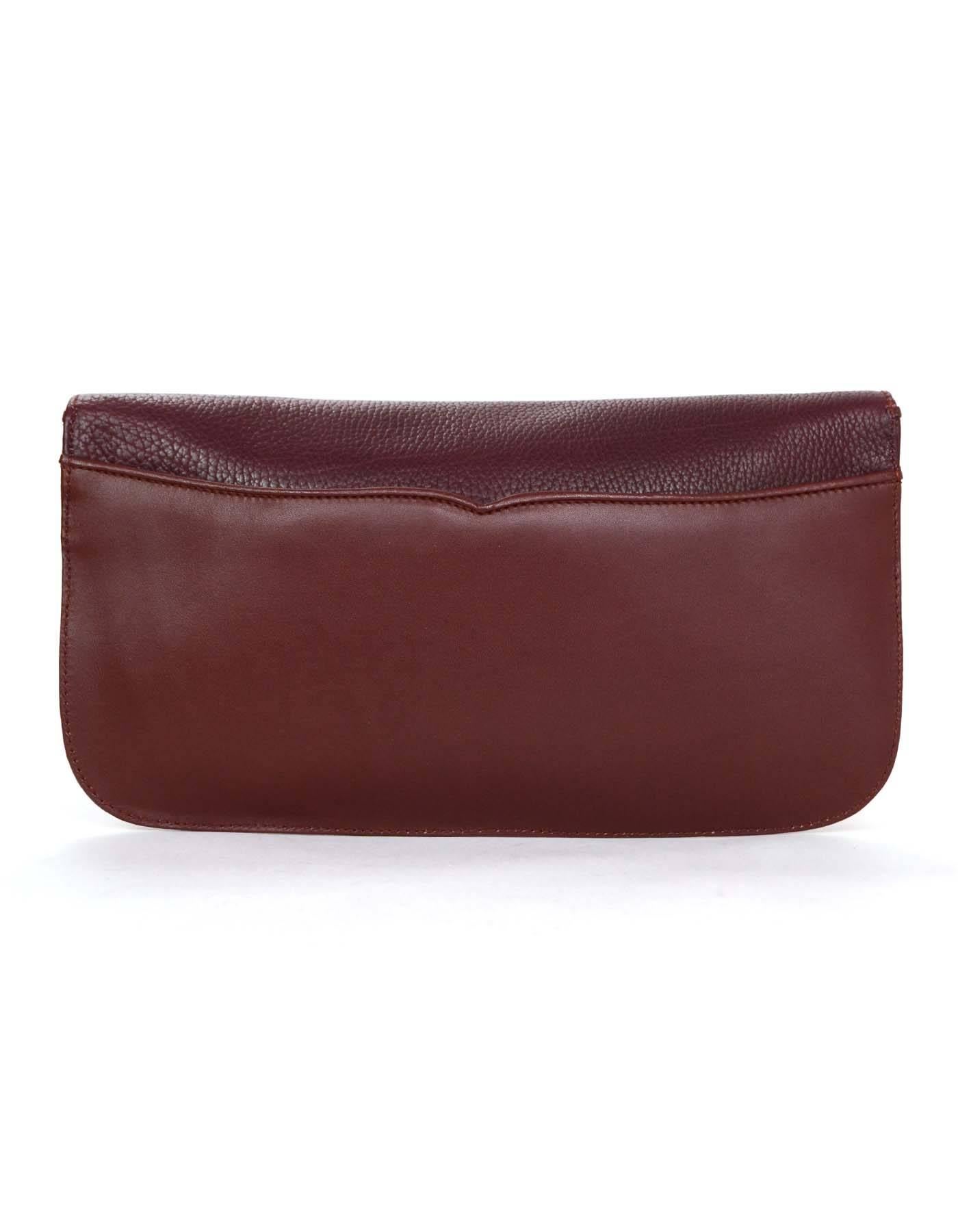 100% Authentic Cartier Burgundy Leather Clutch features textured and smooth leather with gold tone Cartier logo. Back slit pocket allows for extra space in addition to roomy interior.

    Color: Burgundy deep red with slight purple undertones
  