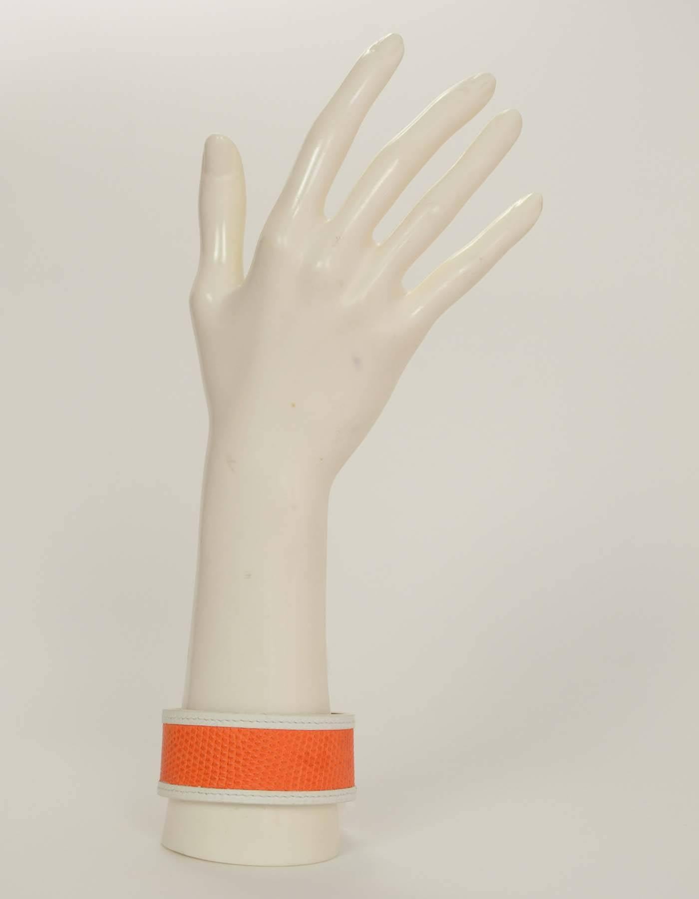 Hermes Orange and White Lizard Bangle

Stamp: Hermes
Closure: None
Color: White and orange
Materials: Leather and lizard
Overall Condition: Very good pre-owned condition with the exception of some discoloration