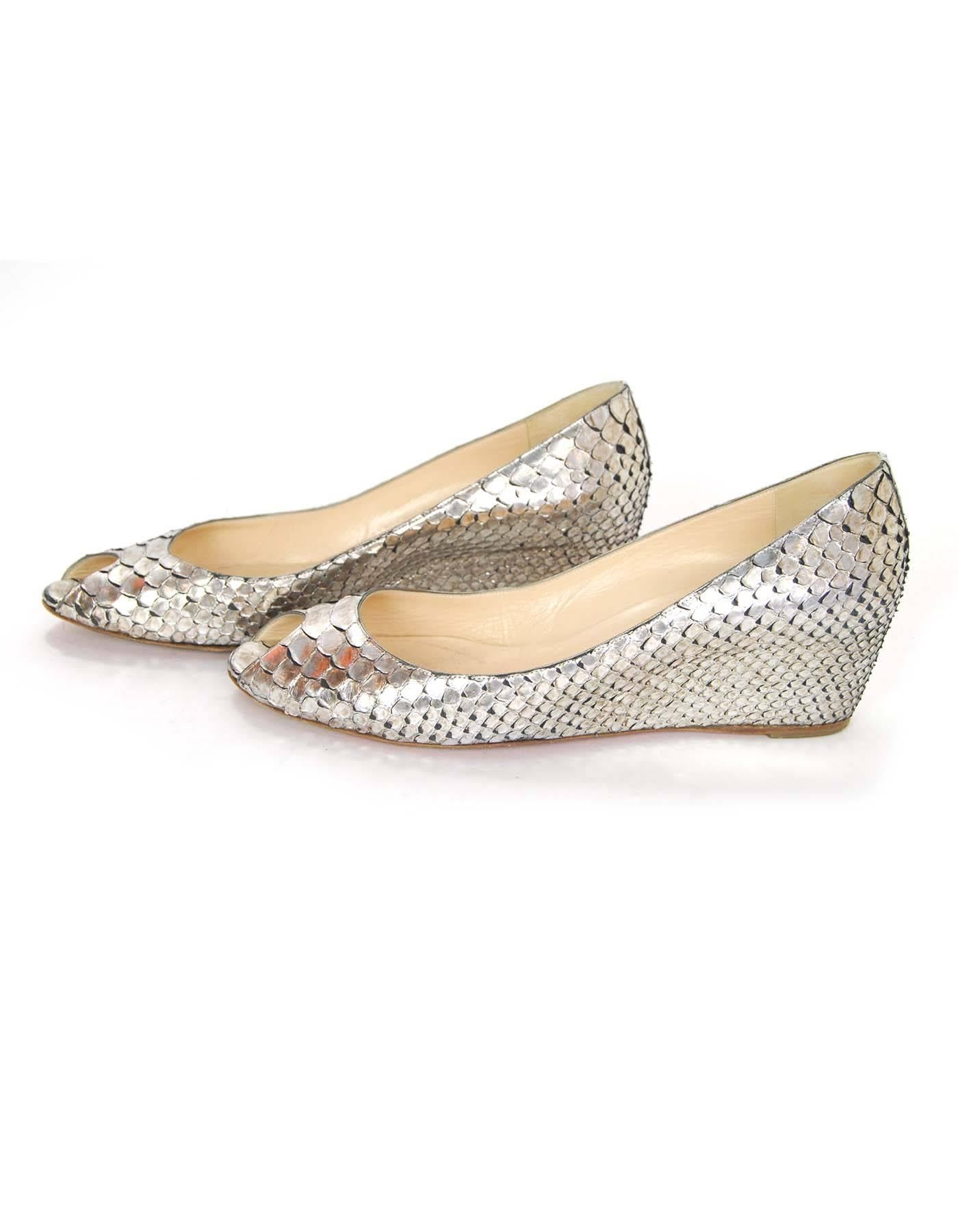 Christian Louboutin Silver Python Open-Toe Wedges Sz 40.5

Made In: Italy
Color: Silver
Materials: Python
Closure/Opening: Slide on
Sole Stamp: Christian Louboutin Made in Italy 40.5
Overall Condition: Very good pre-owned condition with the