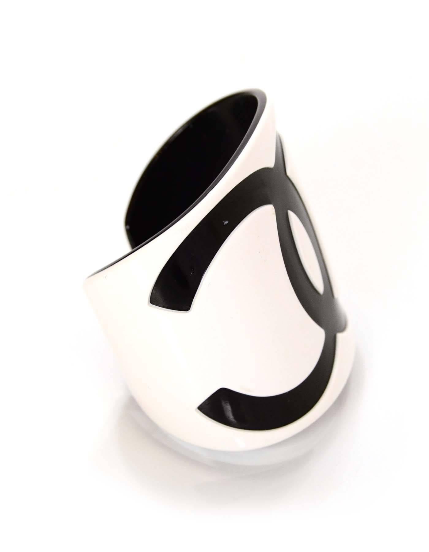 Chanel Black and White Resin CC Cuff

Made In: France
Year of Production: 2001
Color: Black and white
Materials: Resin
Closure: Slide on
Stamp: CHANEL 01 CC P MADE IN FRANCE
Overall Condition: Excellent pre-owned condition with the exception