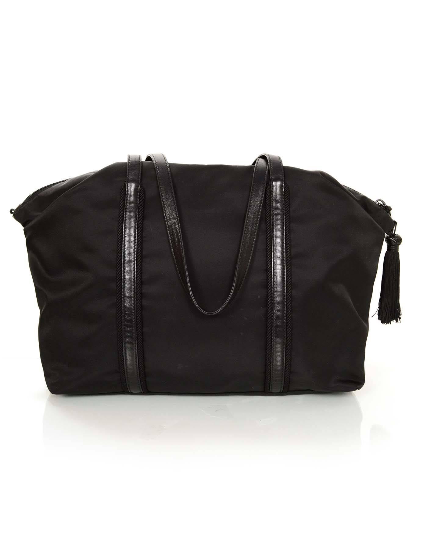 100% Authentic Prada Black Nylon Tassel Duffle Tote Bag 1BG135. Features leather straps and trim and tassel detail.

Made in: Italy
Color: Black
Hardware: Silvertone
Materials: Nylon with canvas and leather trim
Lining: Black monogram