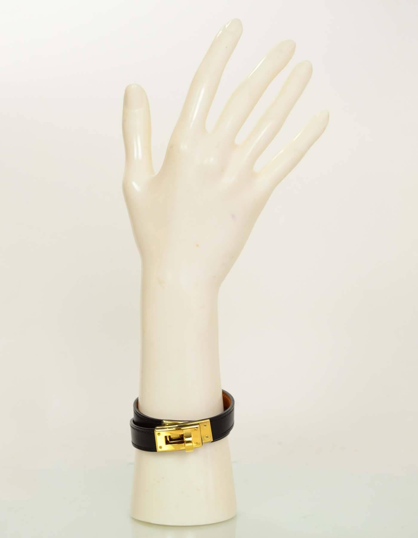 Hermes Kelly Black and GHW Double Tour Bracelet Sz M

Made In: France
Year of Production: 2010
Color: Black and gold
Hardware: Goldtone
Materials: Leather, metal
Closure/Opening: twist lock
Stamp: HERMES PARIS MADE IN FRANCE, N in