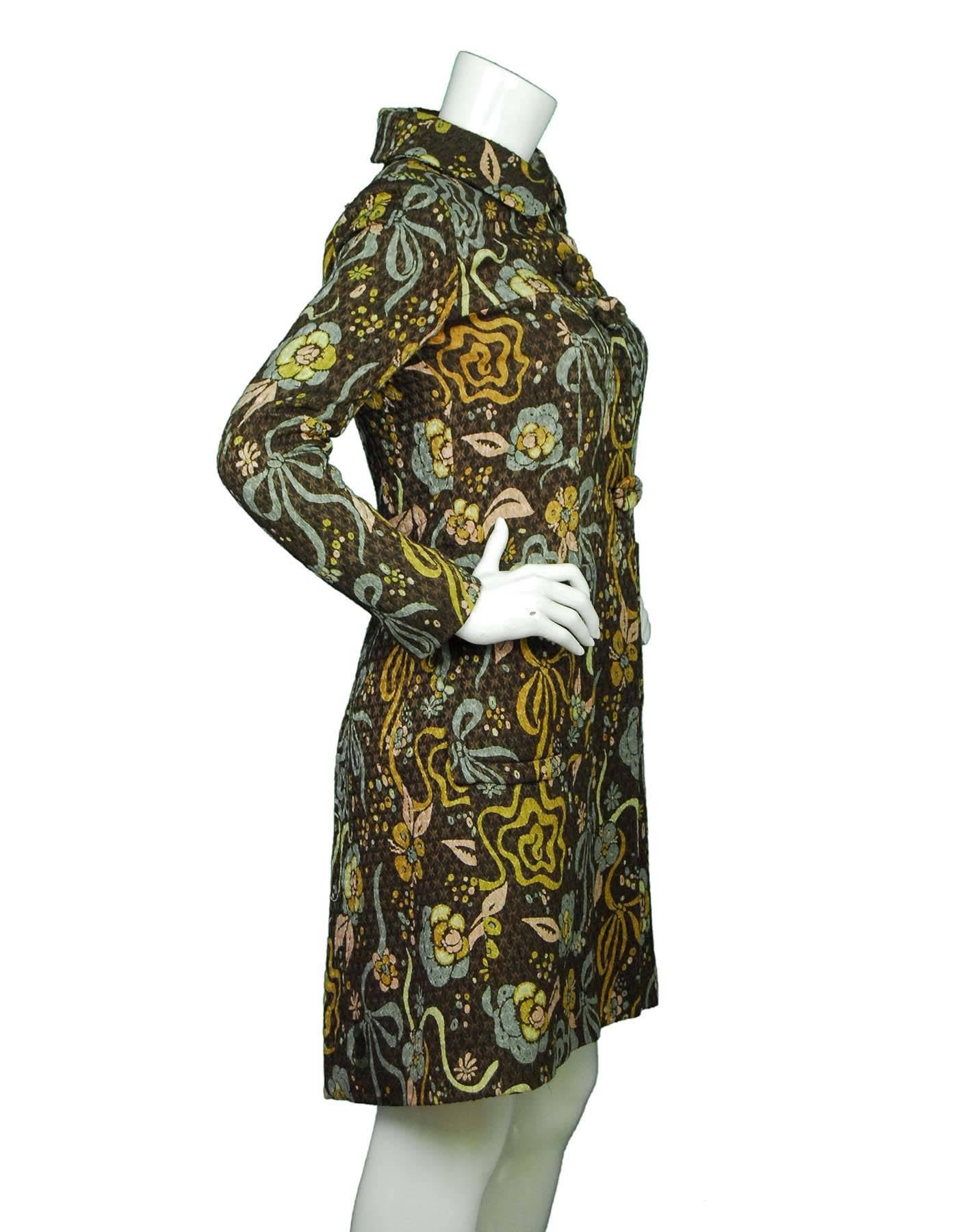 Emanuel Ungaro Brown Floral Coat Sz 6

Made In: Italy
Color: Brown, green, taupe
Composition: 55% pure new wool,  45% silk
Lining: Taupe 100% Silk
Closure/Opening: Front zip button closure
Exterior Pockets: Two hip pockets
Interior Pockets: