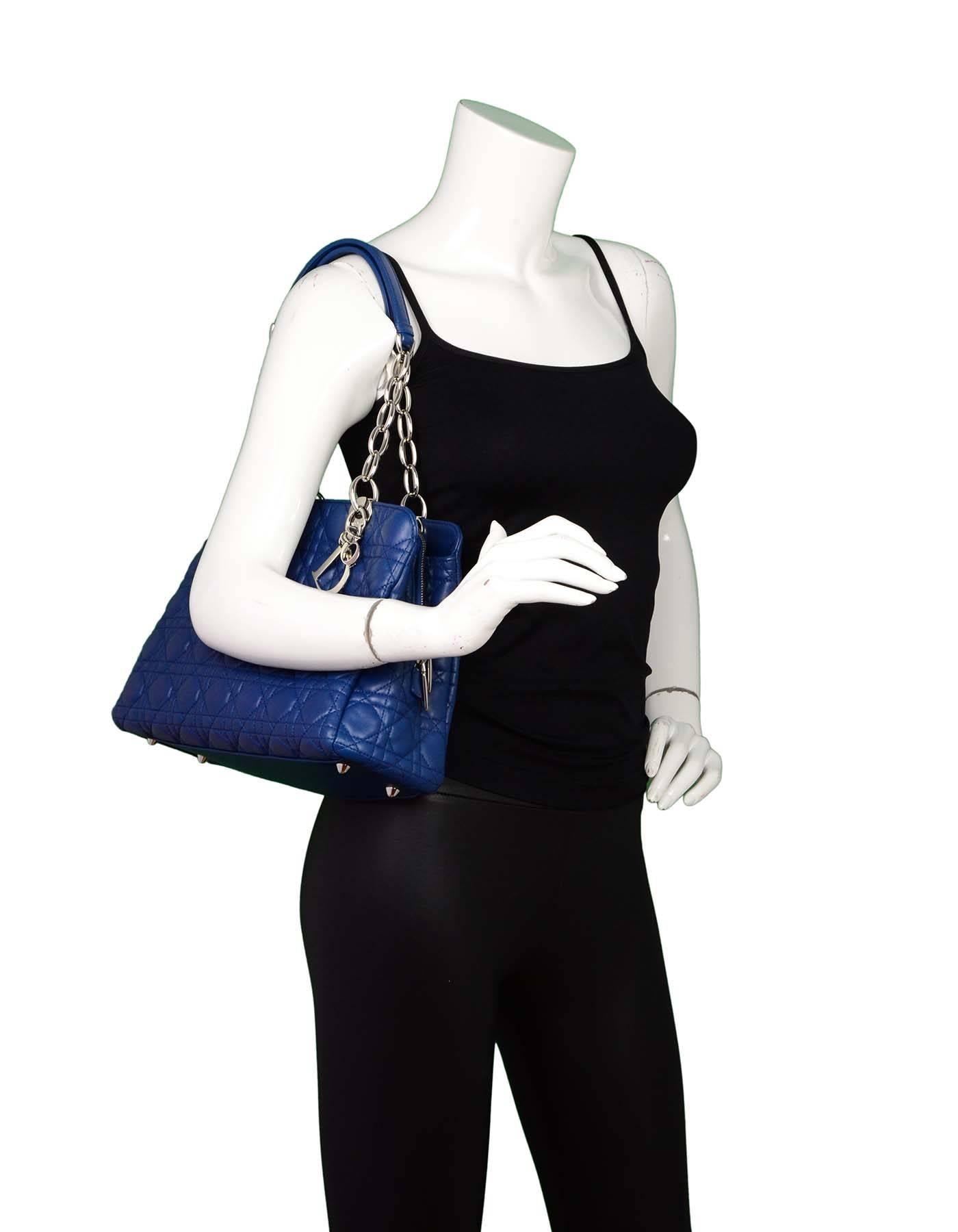 Christian Dior Marine Blue Soft Leather Zipper Shopping Tote
Features quilting throughout and Dior charms

Made In: Italy
Color: Marine blue
Materials: Leather, metal
Opening: Zip top
Exterior Pockets: Front and back
Interior Pockets: Two