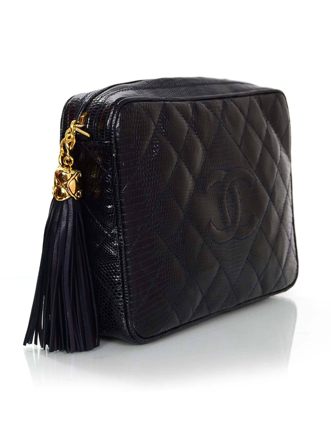 Chanel Navy Lizard Skin Camera Bag 
Features timeless CC at front and quilted goldtone tassel zipper pull

Made In: Italy
Year of Production: 1989-1991
Color: Navy
Hardware: Goldtone
Materials: Lizard skin
Lining: Navy