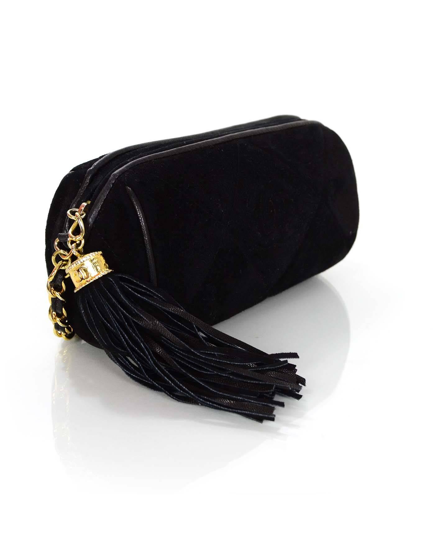 Chanel Quilted Suede Mini Barrel Bag  
Features black tassel and goldtone CC charm

Made In: Italy
Year of Production: 1986-1988
Color: Black
Hardware: Goldtone
Materials: Suede
Lining: Black lining
Closure/Opening: Zip across top
Exterior