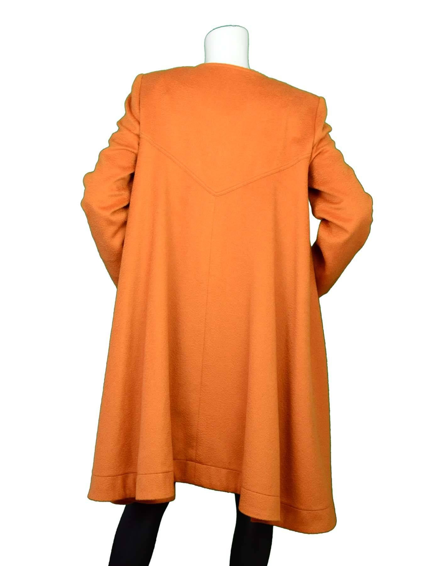 Fendi Burnt Orange Cashmere Swing Coat Sz 42

Made In: Italy
Color: Burnt orange
Composition: 100% Cashmere
Lining: 1/2 lined silk textile
Closure/Opening: Front snap button closure
Exterior Pockets: Two hip pockets
Interior Pockets: