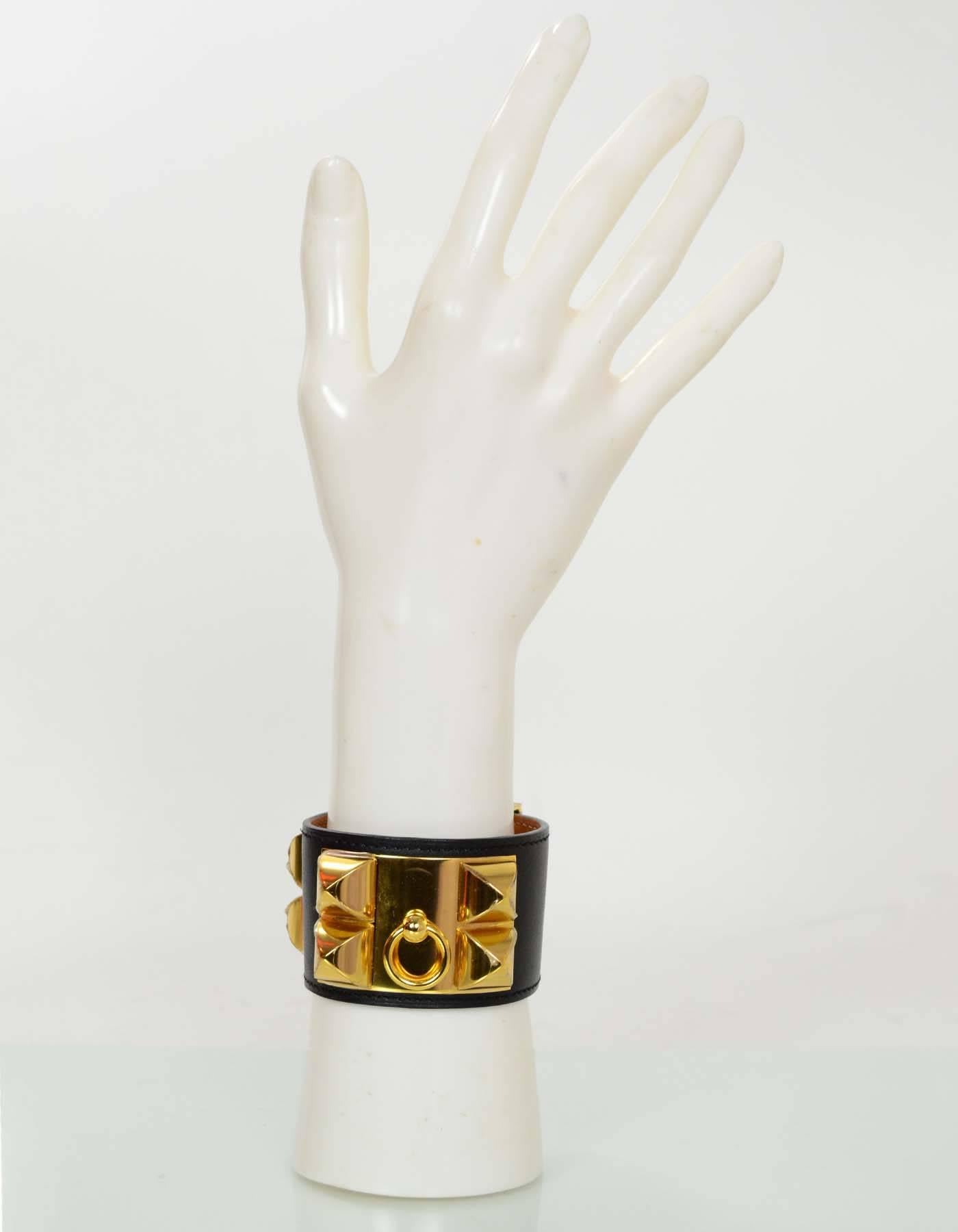 Hermes Black & Gold Collier de Chien CDC Cuff Bracelet sz S

Made In: France
Year of Production: 2013
Color: Black
Hardware: Goldtone
Materials: Leather and metal
Closure: Stud and notch closure
Stamp: Q stamp in square
Overall Condition: