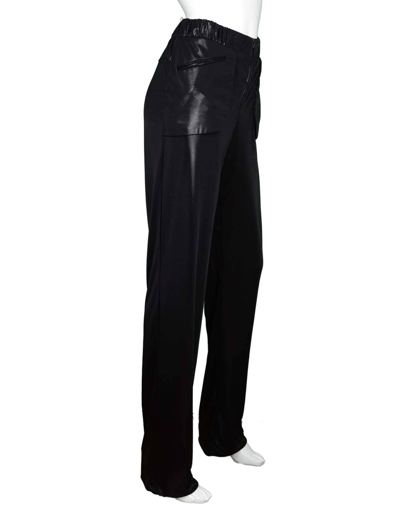 Chanel Black Lustrous Pants Sz 40
Features stretch waistband

Made In: Italy
Year of Production: Current
Color: Black
Composition: 100% Polyester
Lining: None
Closure/Opening: Zip front closure
Exterior Pockets: Faux hip pockets
Overall