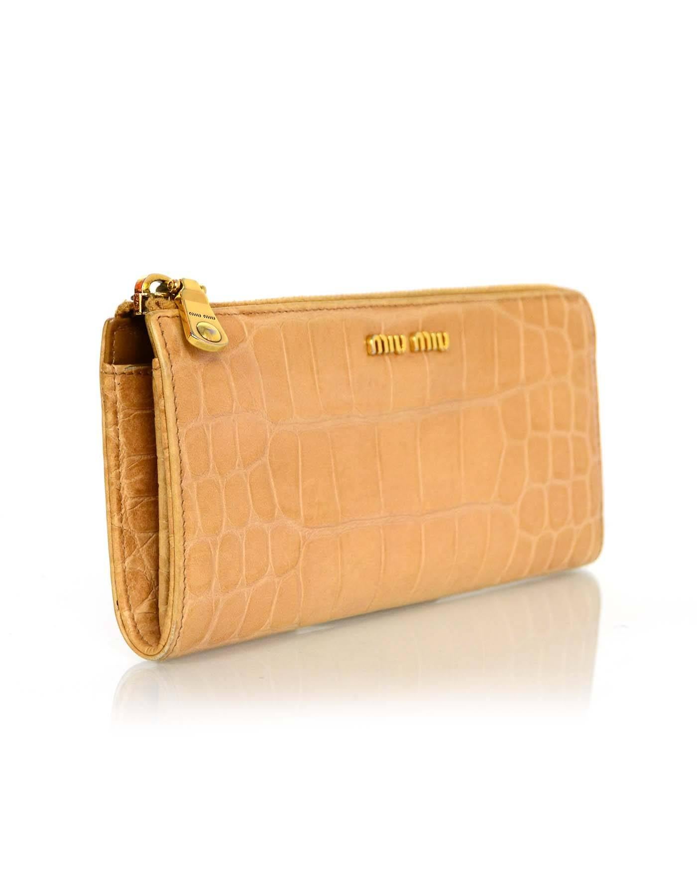 Miu Miu Tan Embossed Crocodile Wallet

Color: Tan
Hardware: Goldtone
Materials: Embossed leather, metal
Lining: Tan leather
Closure/Opening: Zip around closure
Exterior Pockets: None
Interior Pockets: Two compartments, eight card slots,