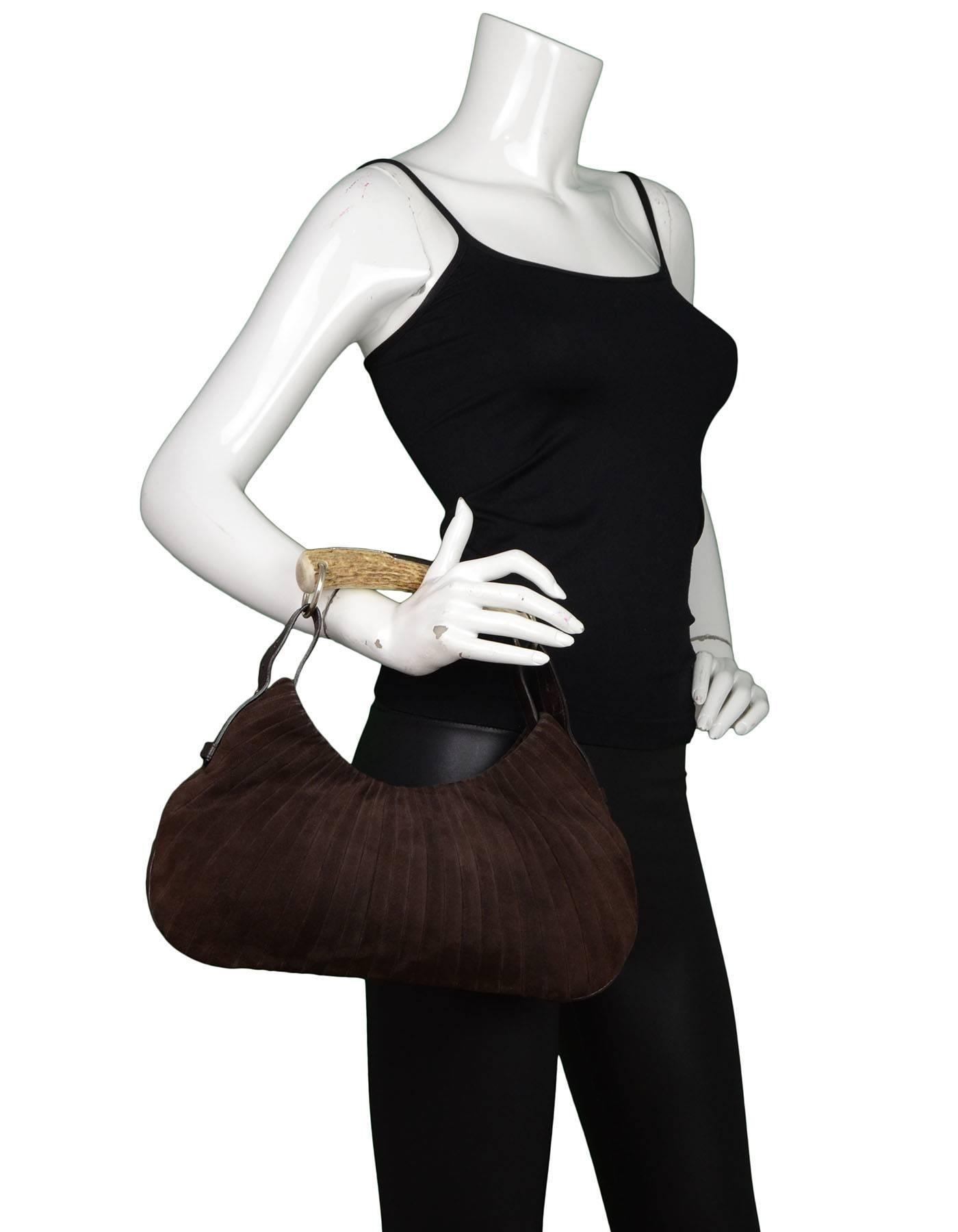 Yves Saint Laurent Brown Suede Mombasa Horn Bag

Made In: Italy
Color: Brown
Hardware: Silvertone
Materials: Suede
Lining: Brown textile
Closure/Opening: Center single snap closure
Interior Pockets: One zip wall pocket
Overall Condition:
