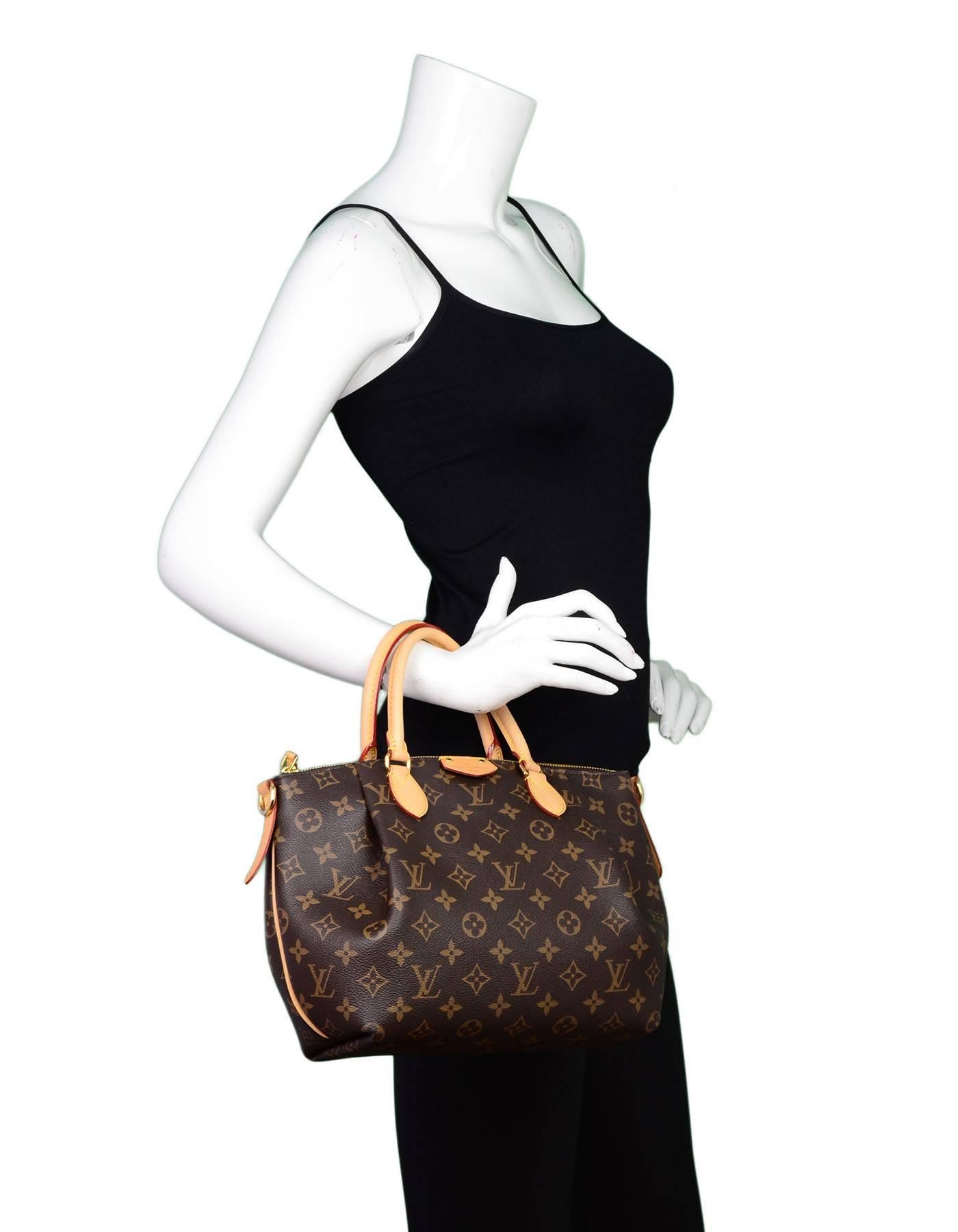 Louis Vuitton Monogram Turenne PM Bag

Made In: France
Year of Production: 2016
Color: Brown
Hardware: Goldtone
Materials: Coated canvas and vachetta leather
Lining: Burgundy canvas
Closure/Opening: Zip top
Exterior Pockets: None
Interior