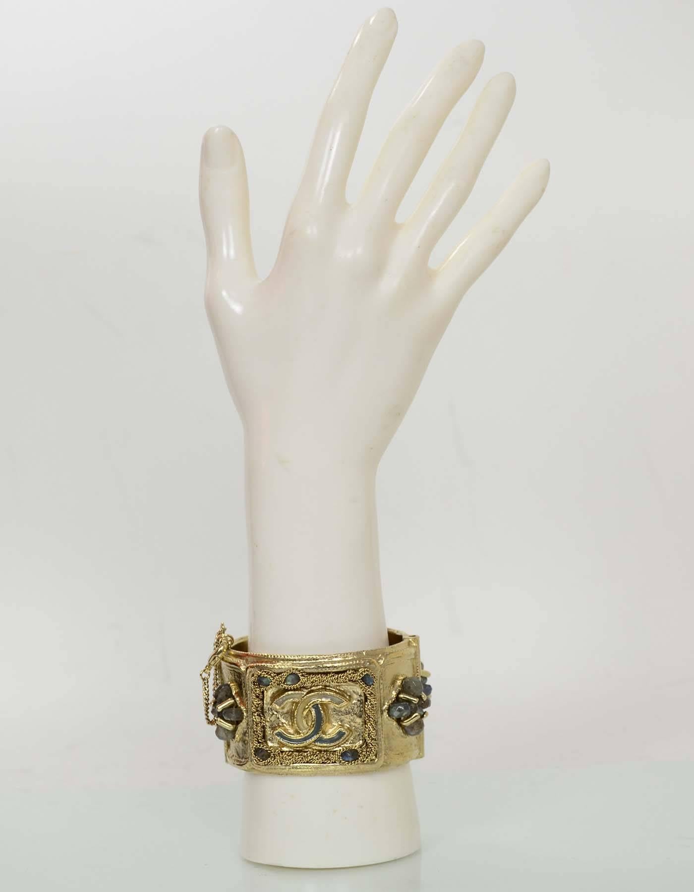 Chanel Goldtone and Jeweled CC Cuff

Made In: France
Year Of Production: 2012
Materials: Metal, stones
Closure/Opening: Pin closure
Stamp: Chanel A12 CC A Made in France
Overall Condition: Excellent pre-owned condition
Includes: Chanel pouch