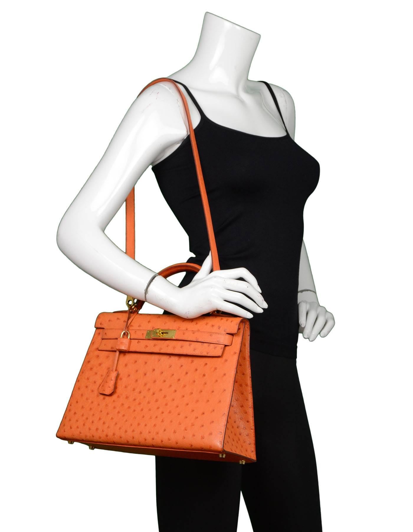 Hermes Orange Ostrich 32cm Sellier Rigid Kelly Bag
Features removable shoulder/crossbody strap

Made In: France
Year of Production: 2002
Color: Orange
Hardware: Goldtone
Materials: Ostrich, metal
Lining: Orange chevre