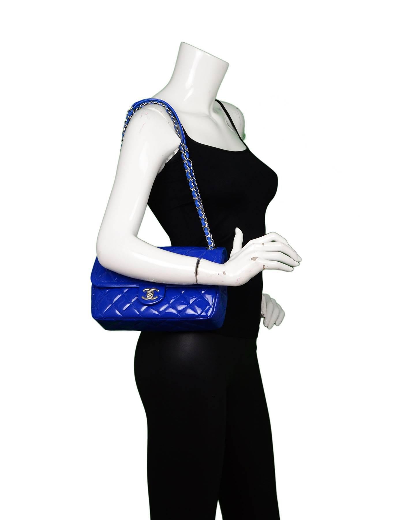 Chanel Blue Patent Leather Flap Bag

Made In: Italy
Year of Production: 2015
Color: Blue
Hardware: Silvertone
Materials: Patent leather, metal, metal
Lining: Black textile
Closure/Opening: Flap top with CC twist lock closure
Exterior