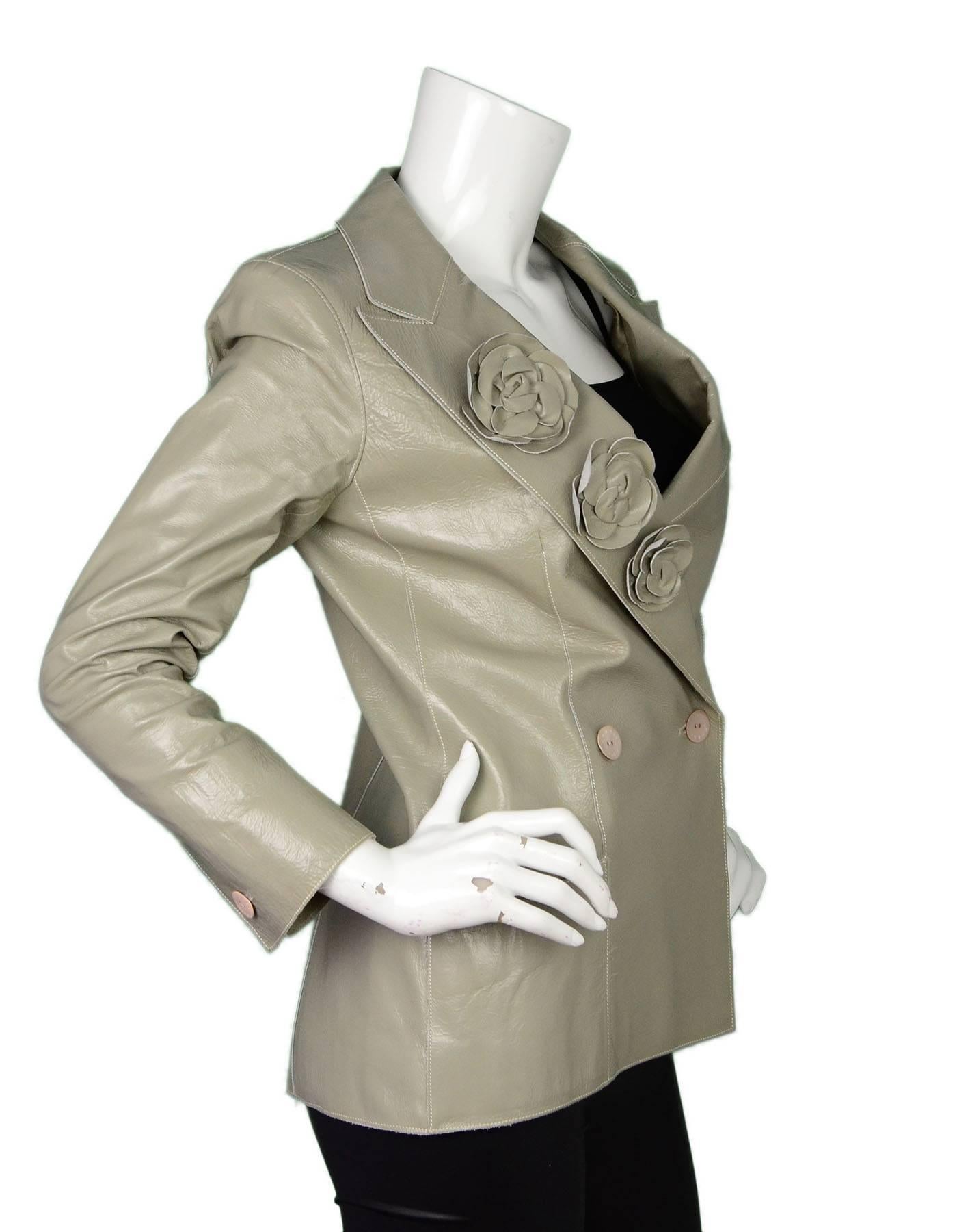 Chanel Moss Green Leather Jacket 
Features 3 camelia flowers

Made In: France
Year of Production: 2003
Color: Moss green
Compsition: 100% calfskin
Lining: Moss green, 100% silk
Closure/Opening: Double breasted button down closure
Exterior
