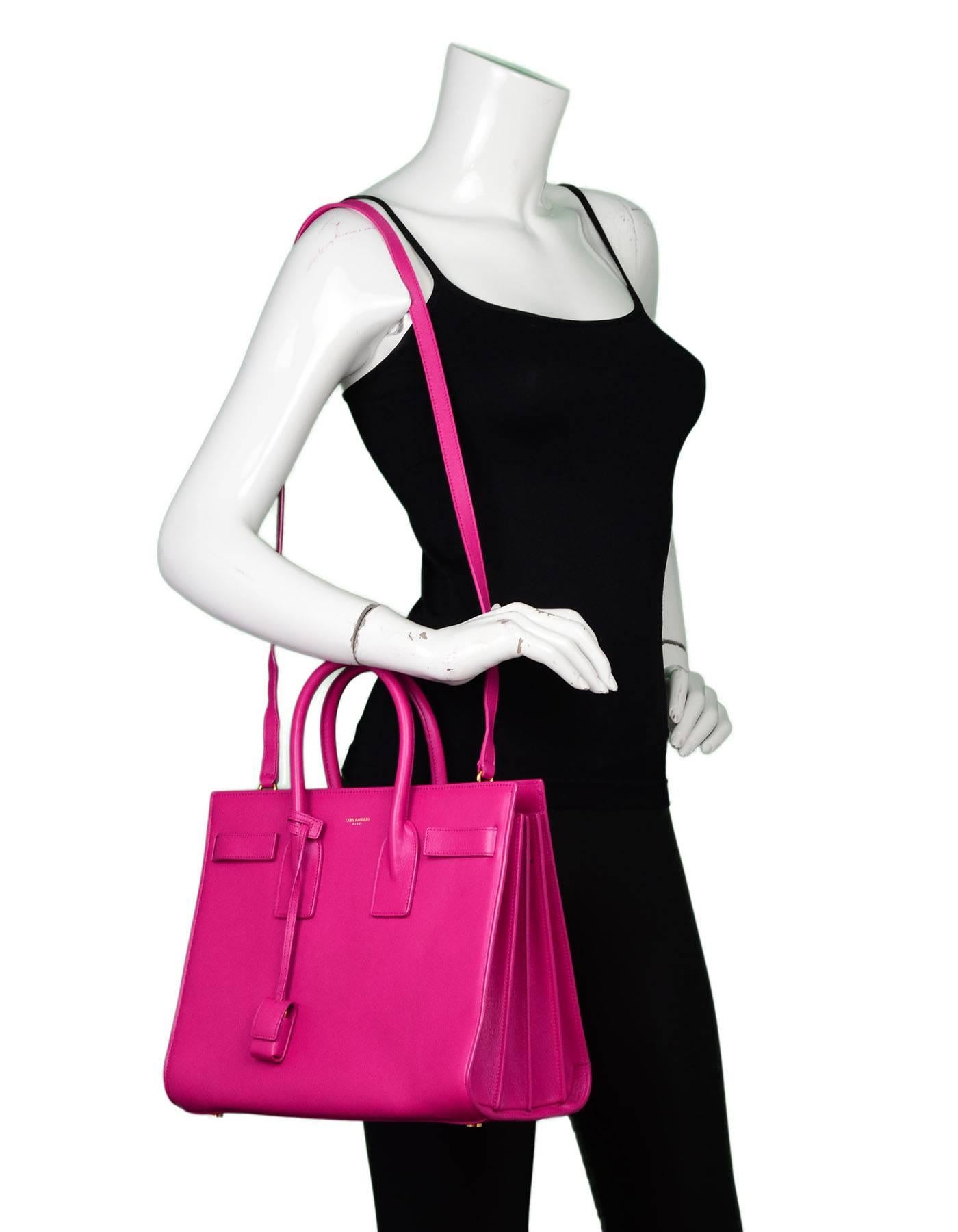 Saint Laurent Pink Small Sac De Jour Tote

Made In: Italy
Color: Pink
Hardware: Goldtone 
Materials: Leather and metal
Lining: Pink suede
Closure/Opening: Open top
Exterior Pockets: None
Interior Pockets: One center zip pouch, one zip wall