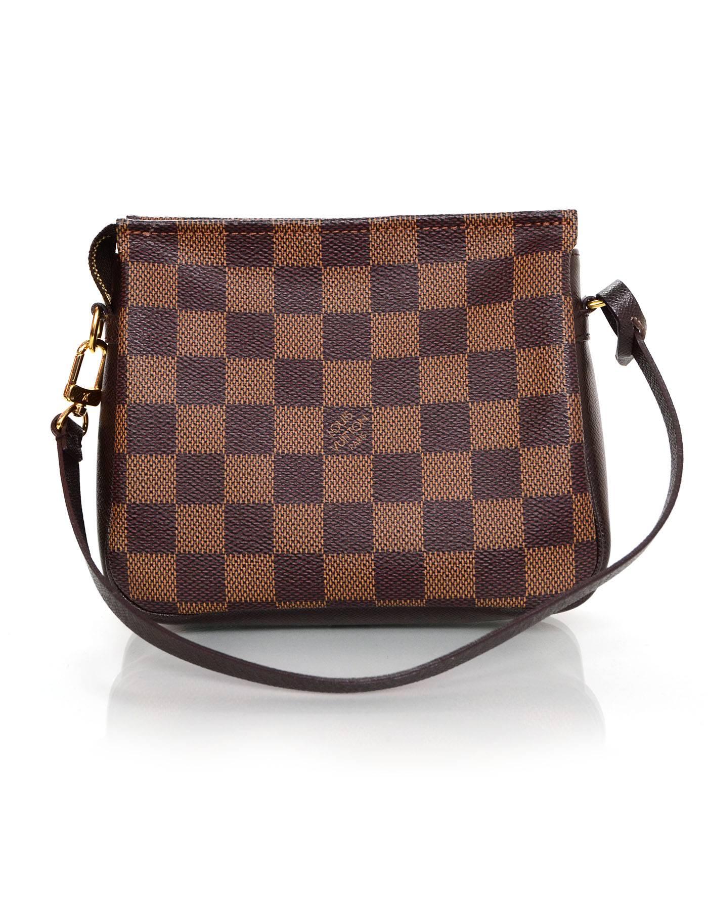 Louis Vuitton Damier Square Trousse Pochette
Shoulder strap can be removed or altered to be worn as a clutch or wristlet

Made In: France
Year of Production: 2000
Color: Brown
Hardware: Goldtone
Materials: Coated canvas and leather
Lining: