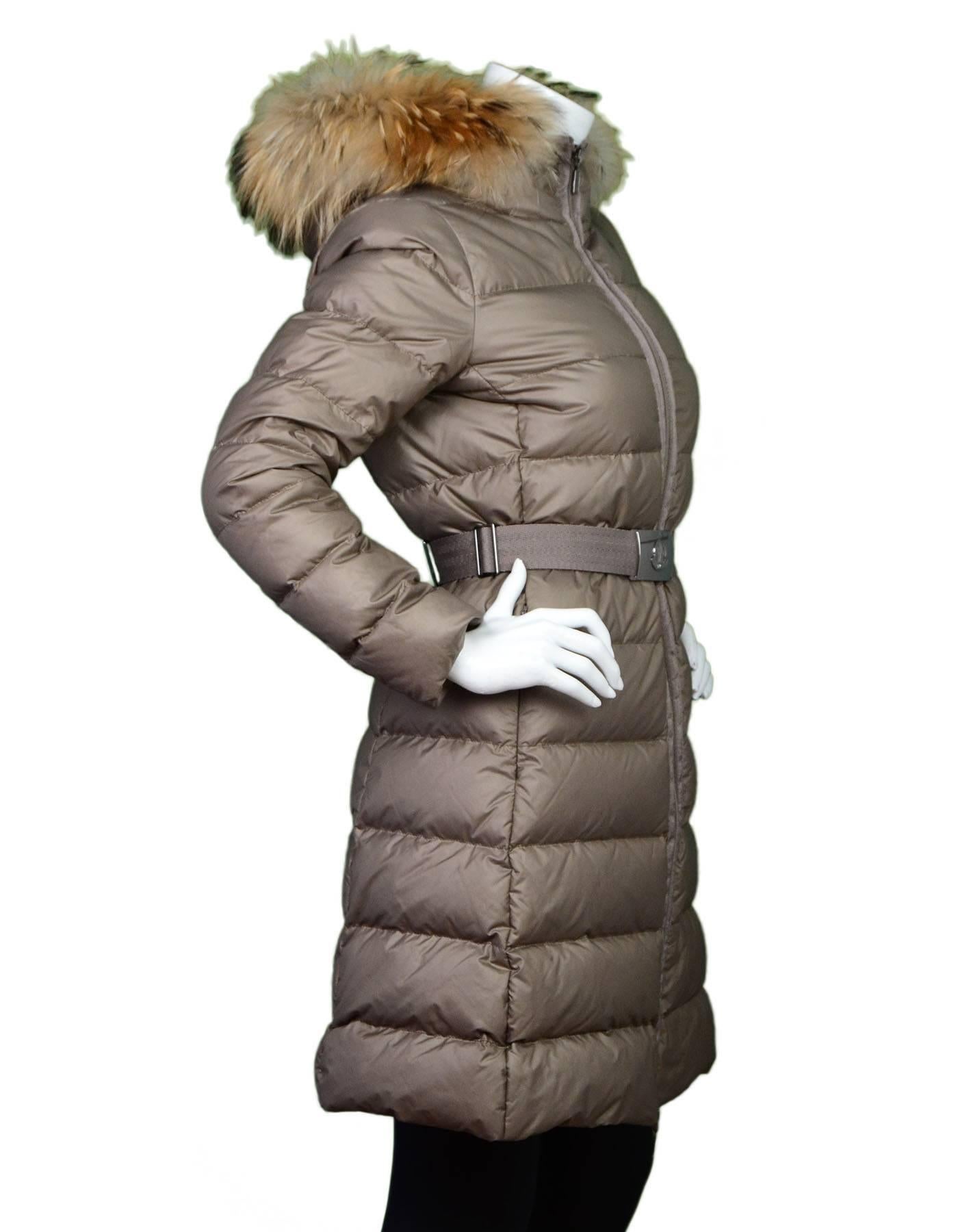 Moncler Nantesfur Long Puffer Coat Sz 1
Features raccoon fur hood and belt at waist

Made In: Armenia
Color: Beige
Composition: 89% Polyester, 11% Nylon
Filling: Down feathers
Lining: Beige nylon
Closure/Opening: Front zip closure
Exterior
