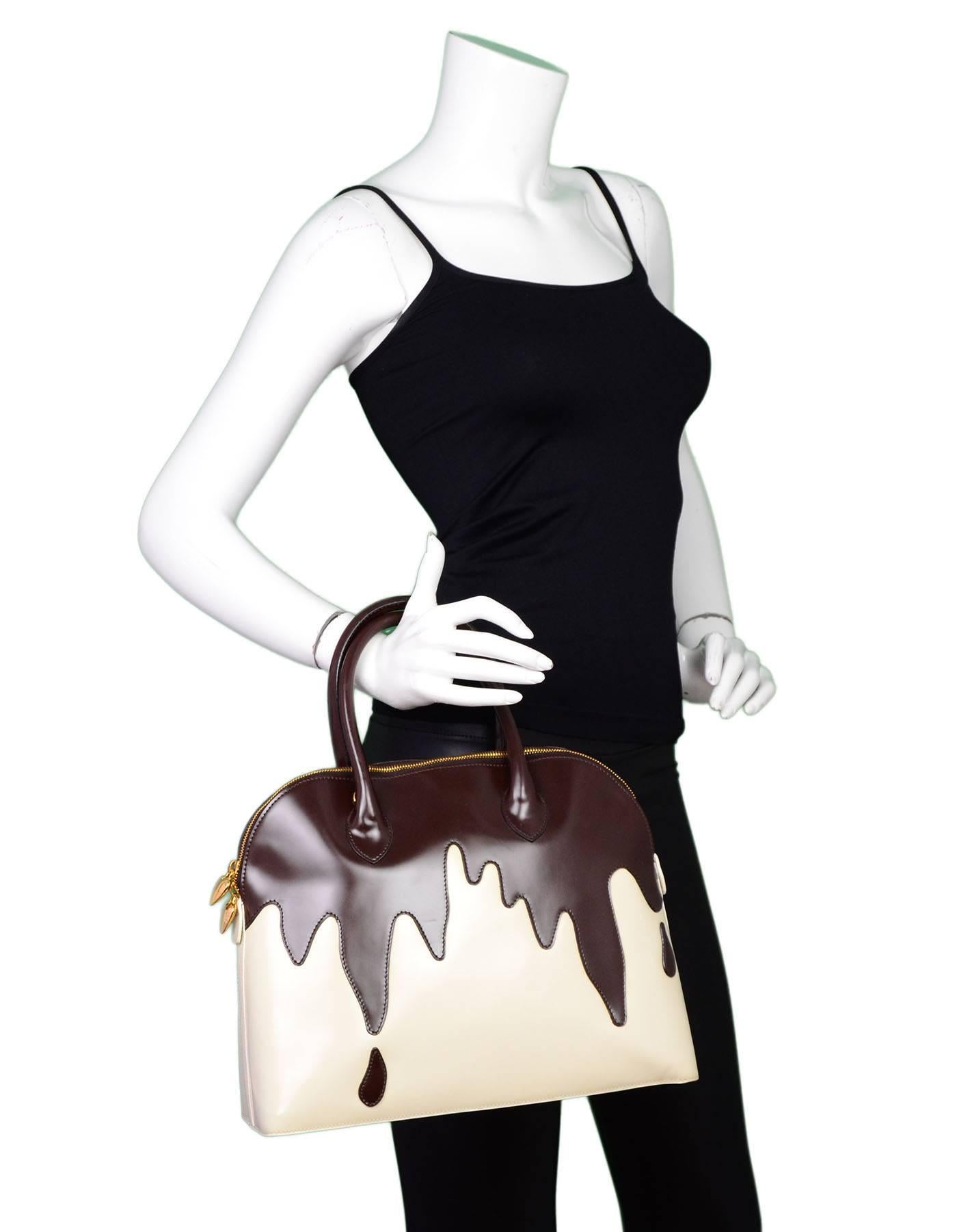 Moschino Dripping Chocolate Handle Bag 

Made In: Italy
Color: Brown, ivory
Interior Lining: Ivory textile
Hardware: Goldtone
Materials: Glazed leather, metal
Closure/Opening: Double zip top
Exterior Pockets: None
Interior Pockets: One zip