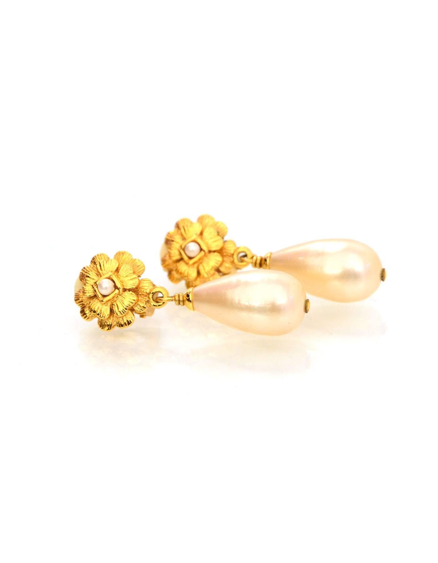 Chanel Vintage Faux Pearl Clip-On Drop Earrings
Features camellia flower

Made In: France
Year of Production: Season 29
Color: Gold and ivory
Materials: Metal and faux pearl
Stamp: Chanel 2 CC 9 Made in France
Closure: Clip on
Overall