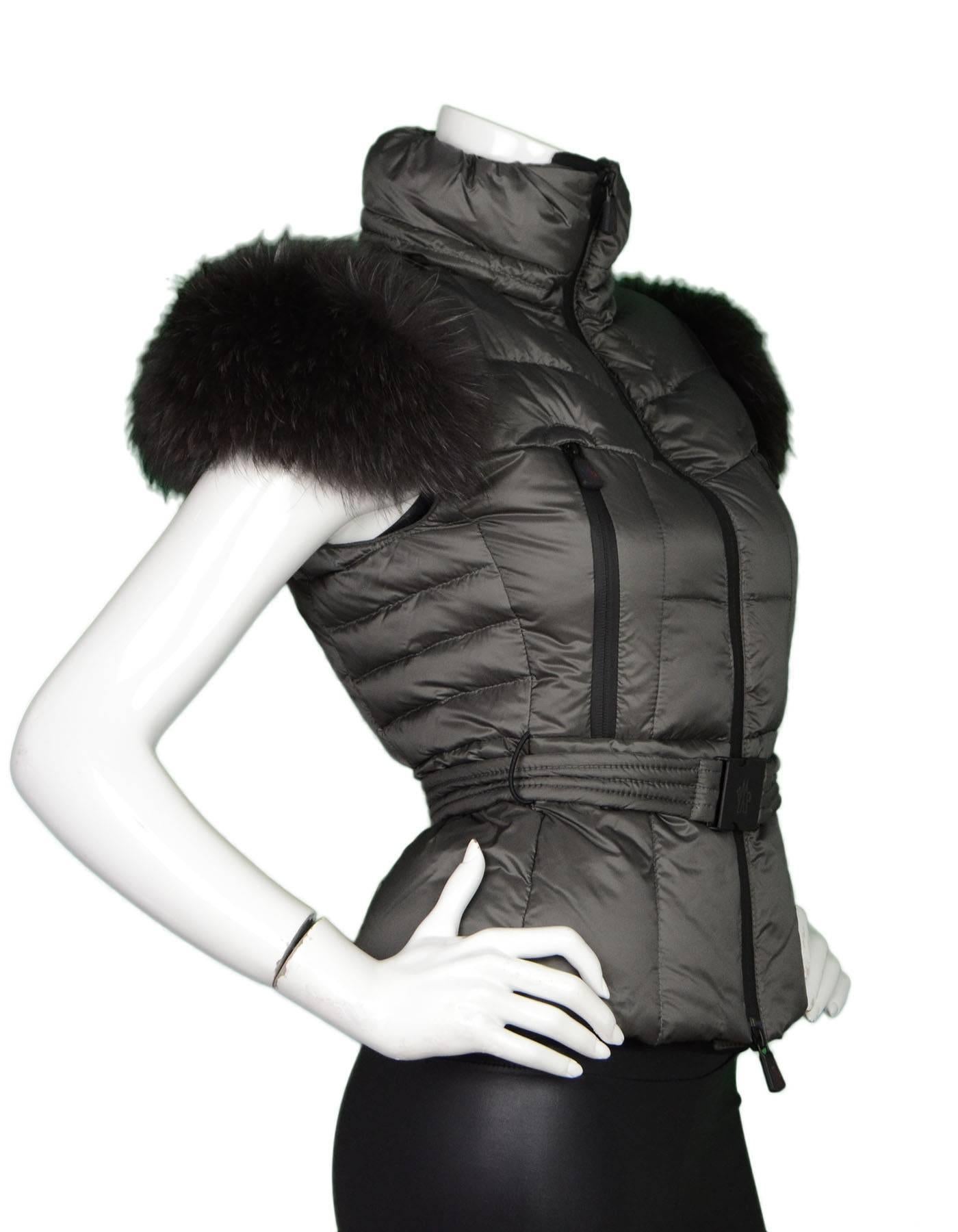 Moncler Dark Grey Down Vest Sz 0 NWT
Features detachable raccoon fur at shoulders

Made In: Romania
Color: Dark grey
Composition: 64% Nylon, 36%  Polyurethane
Lining: Black, 100% Nylon
Filling: Down feathers
Closure/Opening: Double zip up