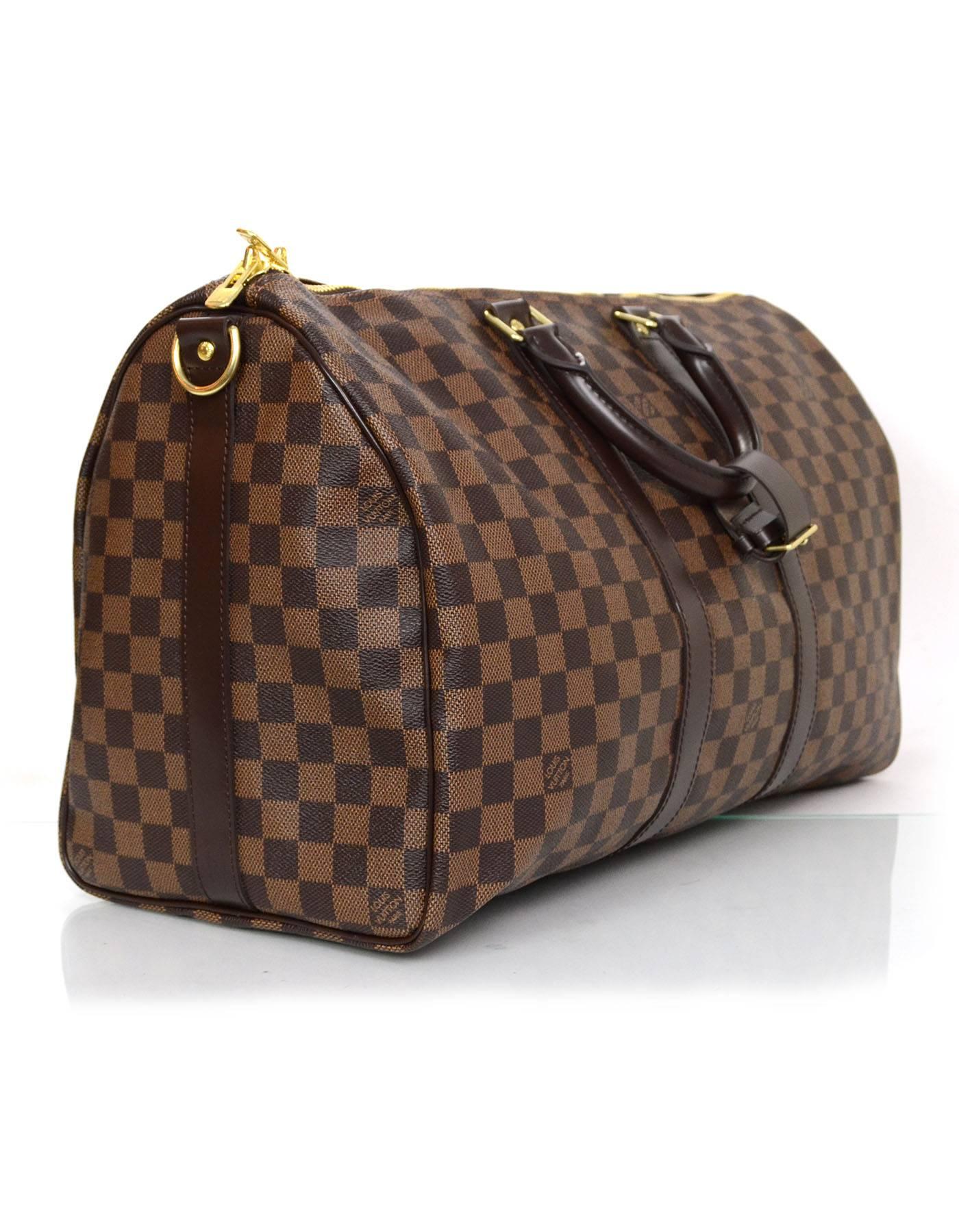 Louis Vuitton Damier Keepall Bandouliere 45
Features optional shoulder/crossbody strap

Made In: France
Year of Production: 2015
Color: Brown and tan
Hardware: Goldtone
Materials: Coated canvas and leather
Lining: Brown
