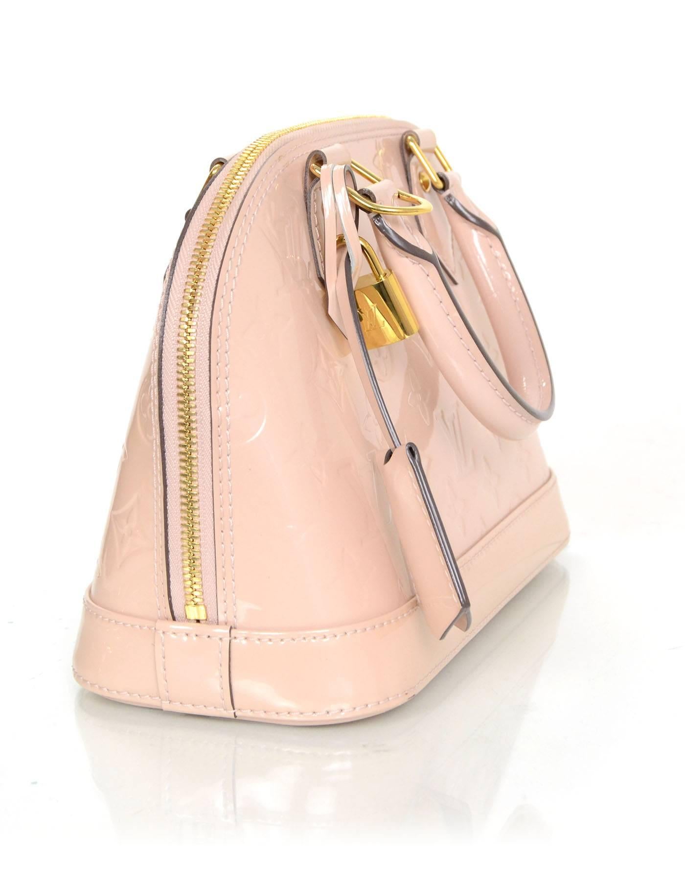 Louis Vuitton Nude Monogram Vernis Alma BB
Features optional shoulder/crossbody strap
Made In: France
Year of Production: 2013
Color: Nude
Hardware: Goldtone
Materials: Vernis leather (patent leather)
Lining: Nude canvas
Closure/Opening:
