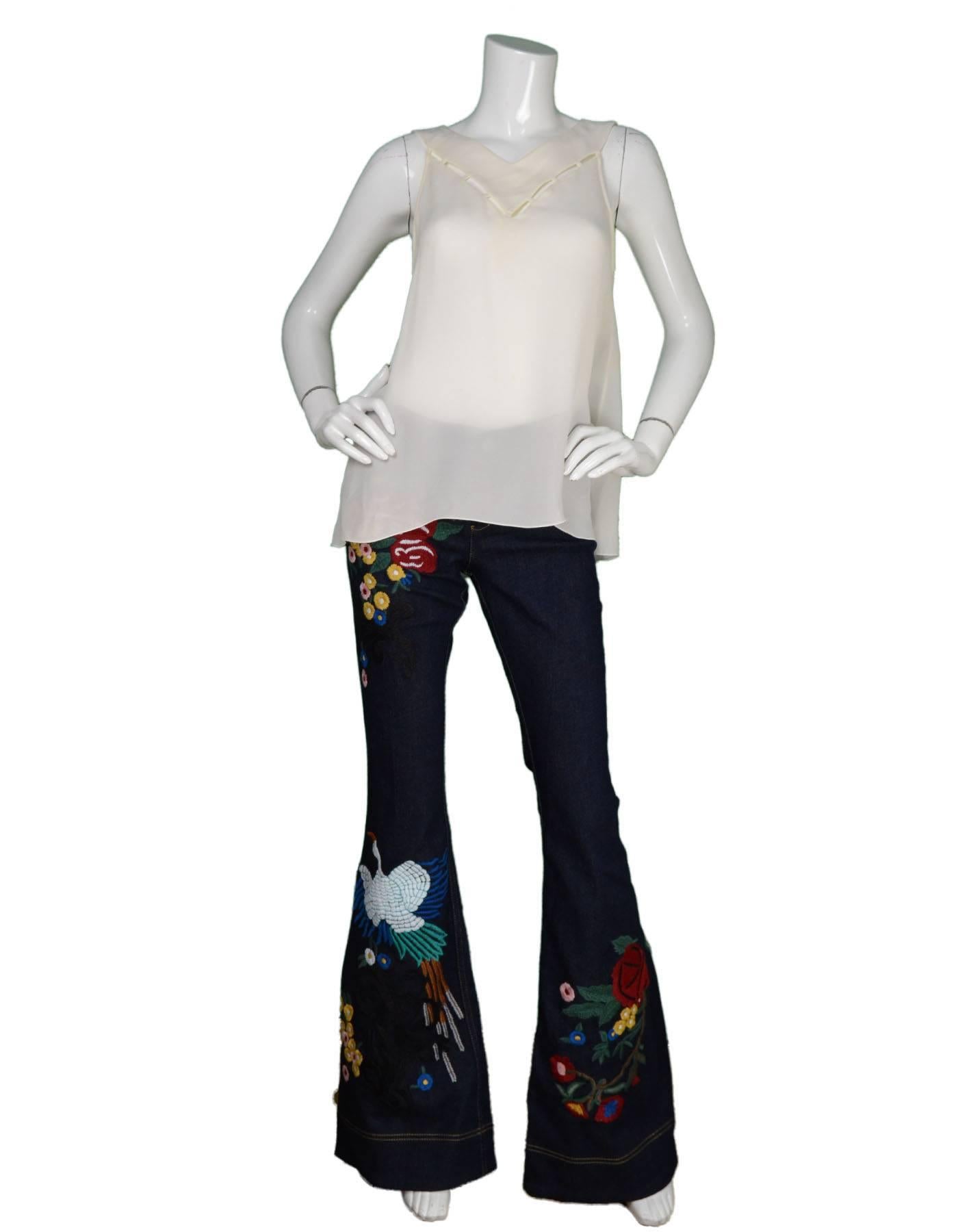 Alice & Olivia NEW Ltd ed. Denim Bell Bottoms
Features multi-colored embroidery throughout

Made In: India
Color: Blue and multi-colored
Composition: 62% cotton, 32% lyocell, 5% polyester, 1% elastane
Lining: None
Closure/Opening: Front
