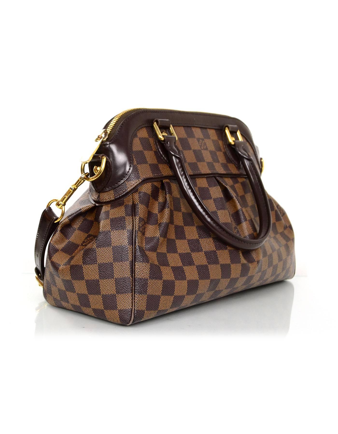 Louis Vuitton Damier Trevi PM Bag 

Features optional detachable shoulder strap
Made In: U.S.A
Year of Production: 2009
Color: Brown
Hardware: Goldtone
Materials: Coated canvas and leather
Lining: Rust orange microfiber
Closure/Opening: Zip