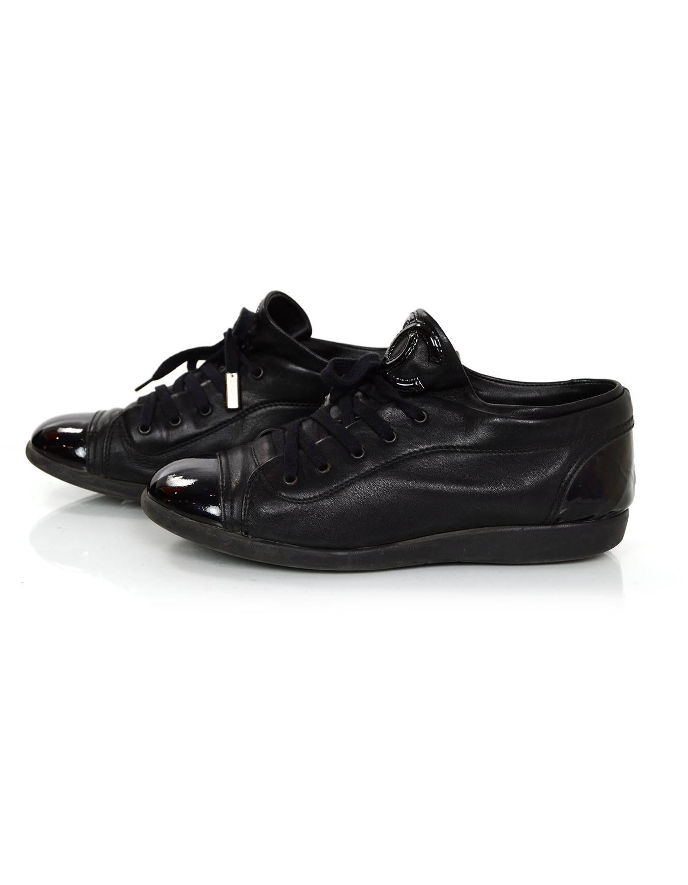 Chanel Black Leather Sneakers
Features patent leather toe and heel cap

Made In: Italy
Color: Black
Materials: Leather and patent leather
Closure/Opening: Lace up
Sole Stamp: Chanel Made in Italy
Overall Condition: Excellent pre-owned