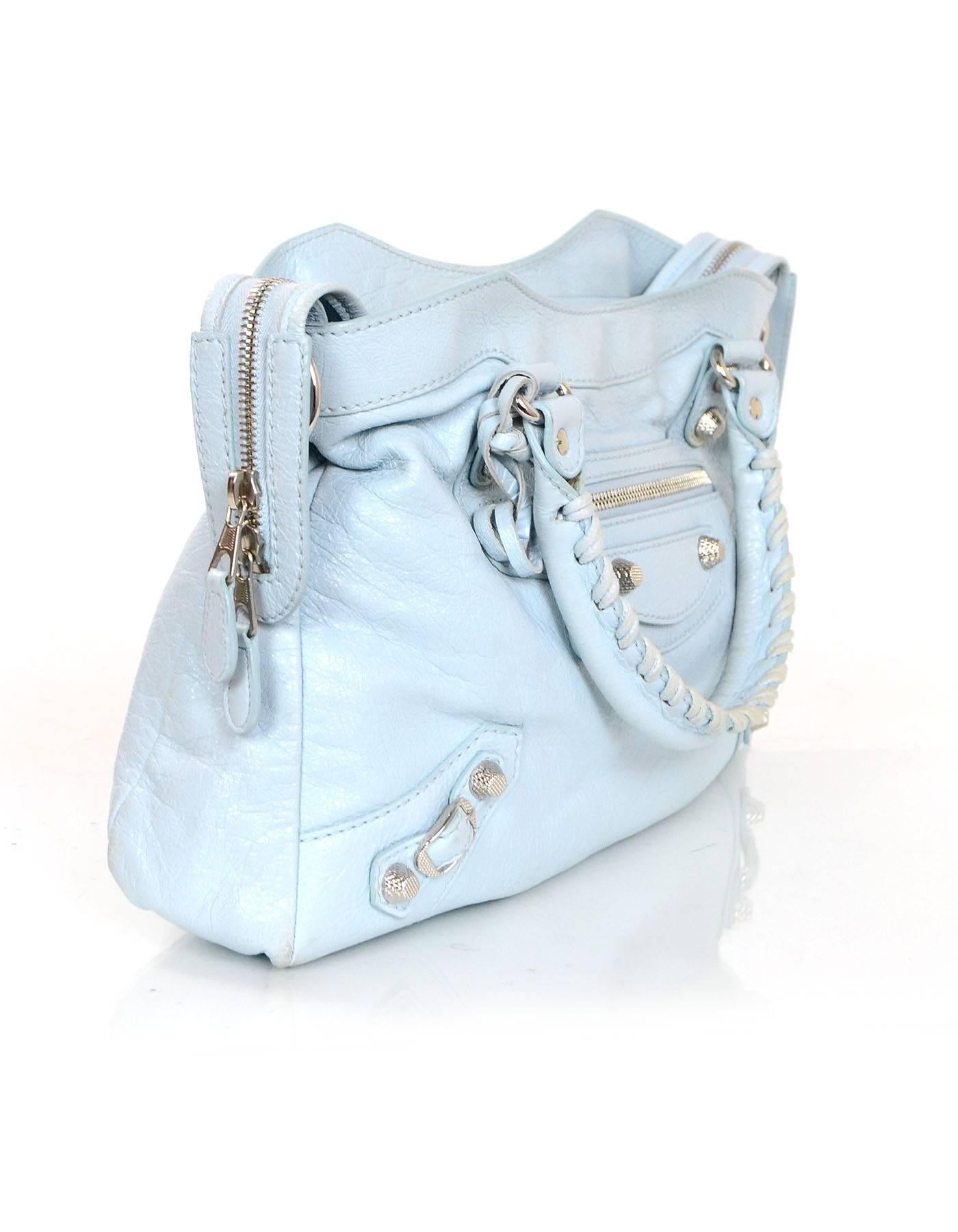 Balenciaga Baby Blue Town Bag 
Features optional shoulder/crossbody strap and detachable travel mirror

Made In: Italy
Year of Production: 2014
Color: Baby blue
Hardware: Silvertone
Materials: Distressed leather
Lining: Black