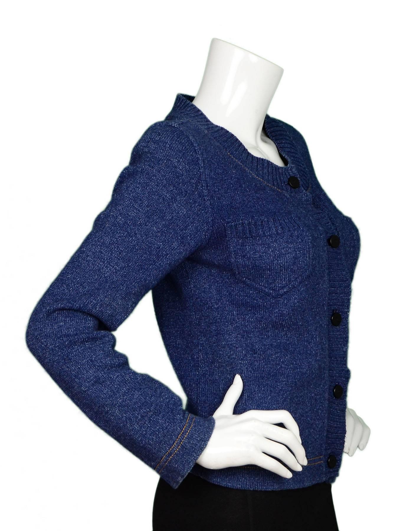 Chanel Blue Denim Knit Cardigan Sweater 
Features light padding in shoulders for a more structured look
Made In: Italy
Year of Production: 1999
Color: Blue
Composition: 100% cotton
Lining: None
Closure/Opening: Button down front
Exterior
