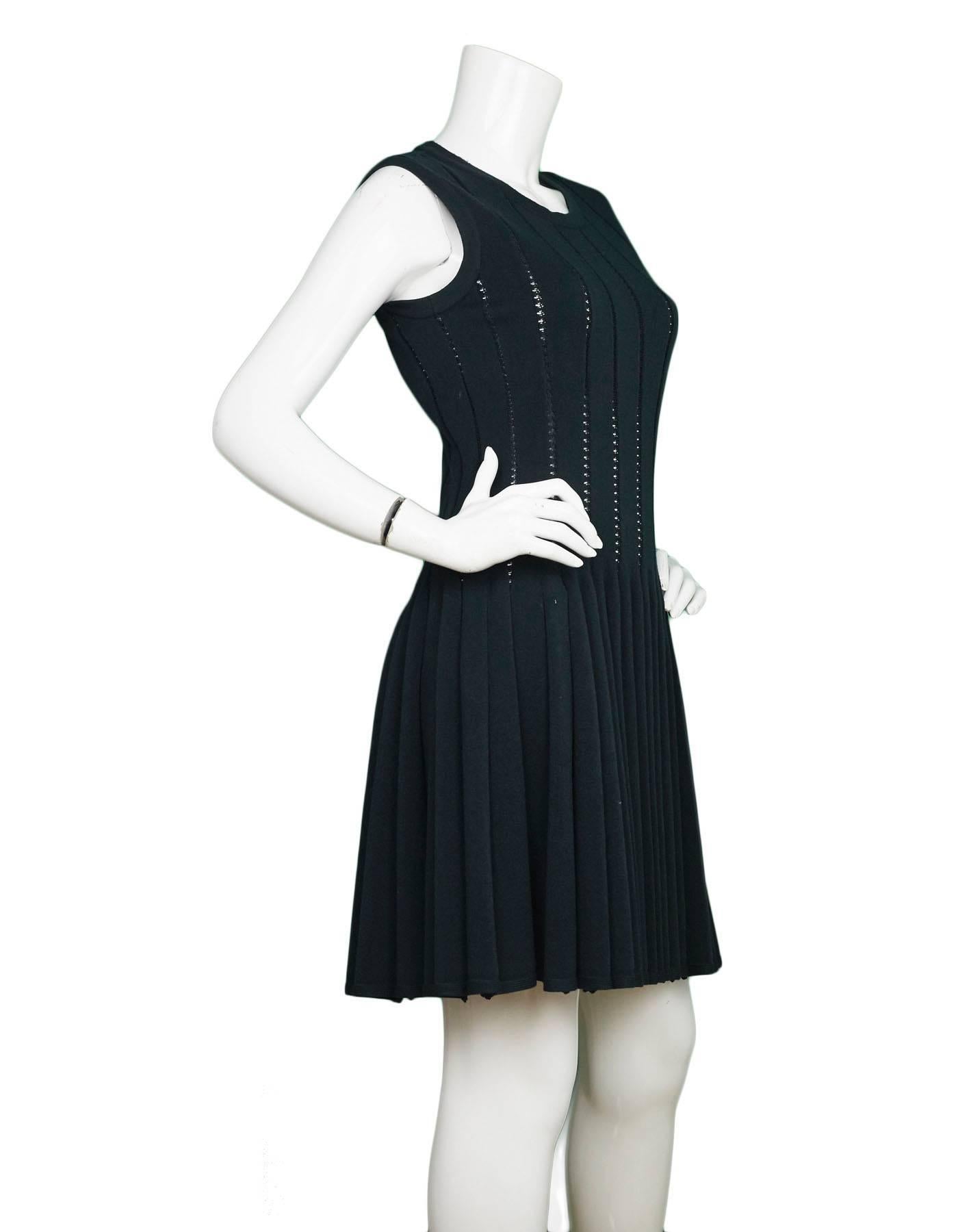 Alaia Dark Green Wool Fit-Flare Dress 
Features perforated vertical knit design throughout dress

Made In: Italy
Color: Dark green
Composition: 80% wool, 10% polyester, 5% cotton, 5% nylon
Lining: None
Closure/Opening: Back center zipper
Exterior