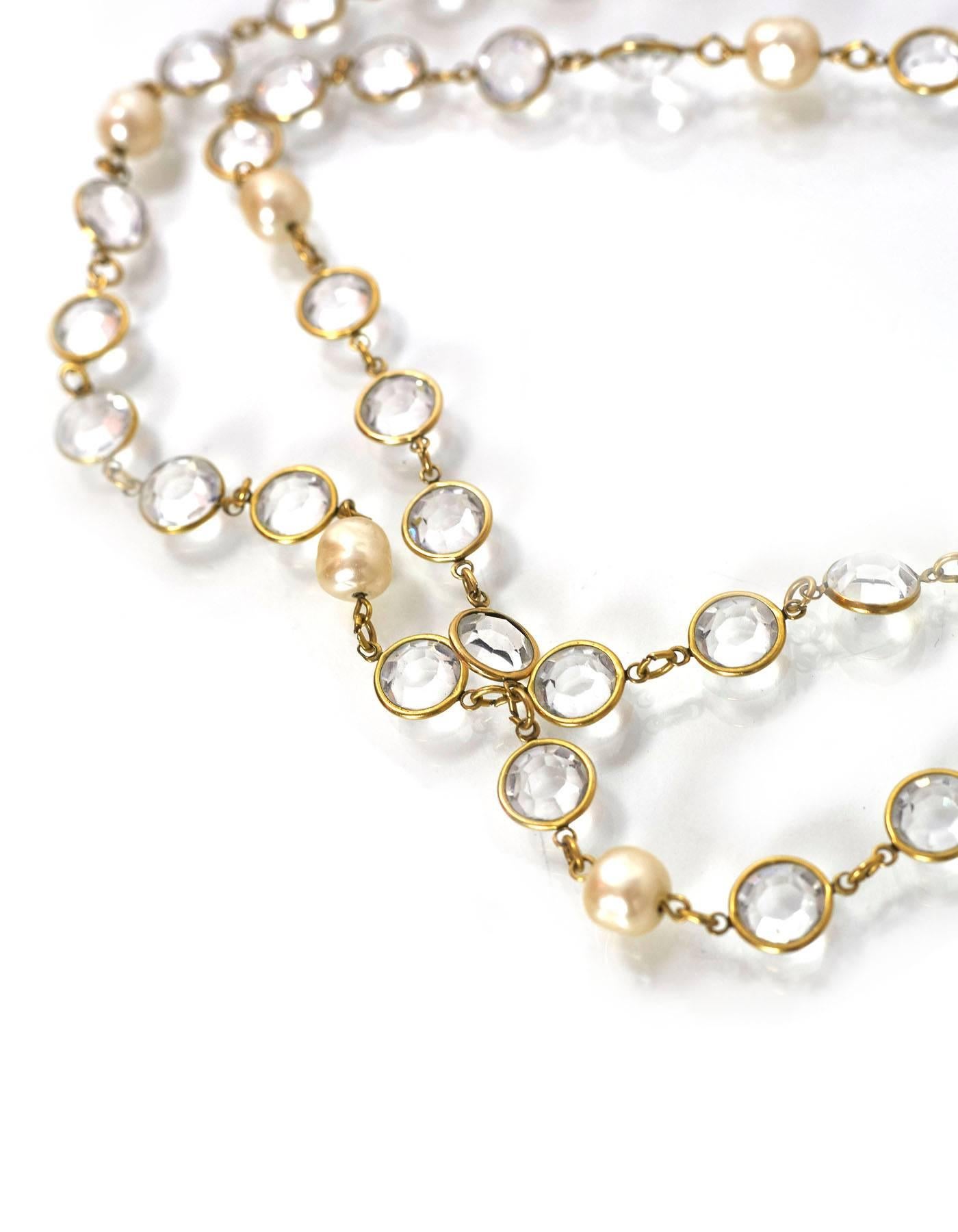 Chanel Crystal & Pearl Sautoir Necklace

Made In: France
Year of Production: 1981
Color: Ivory and clear
Materials: Crystal, faux pearl and metal
Closure/Opening: None
Stamp: Chanel CC 1981
Overall Condition: Excellent vintage, pre-owned