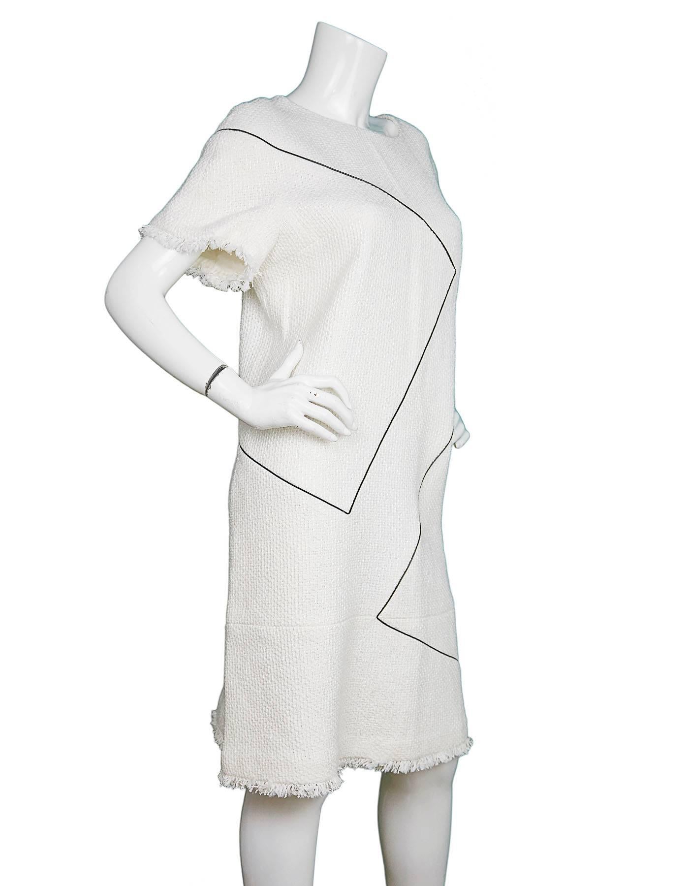 Chanel Pearlized Ivory Shift Dress 
Features black piping throughout

Made In: France
Color: Ivory and black
Composition: 58% cotton, 23% polyurethane, 10% nylon, 5% acrylic, 4% wool
Lining: Ivory, 100% silk
Closure/Opening: Back center zip