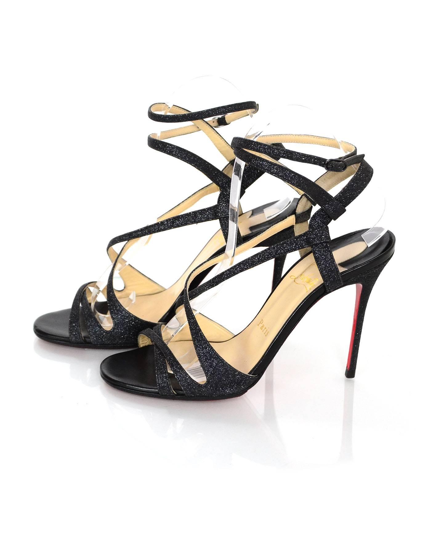 Christian Louboutin Charcoal Glitter Audrey Sandals 

Made In: Italy
Color: Charcoal
Materials: Glitter covered leather
Closure/Opening: ankle wrap strap with buckle and notch closure
Sole Stamp: Christian Louboutin Made in Italy 37
Retail