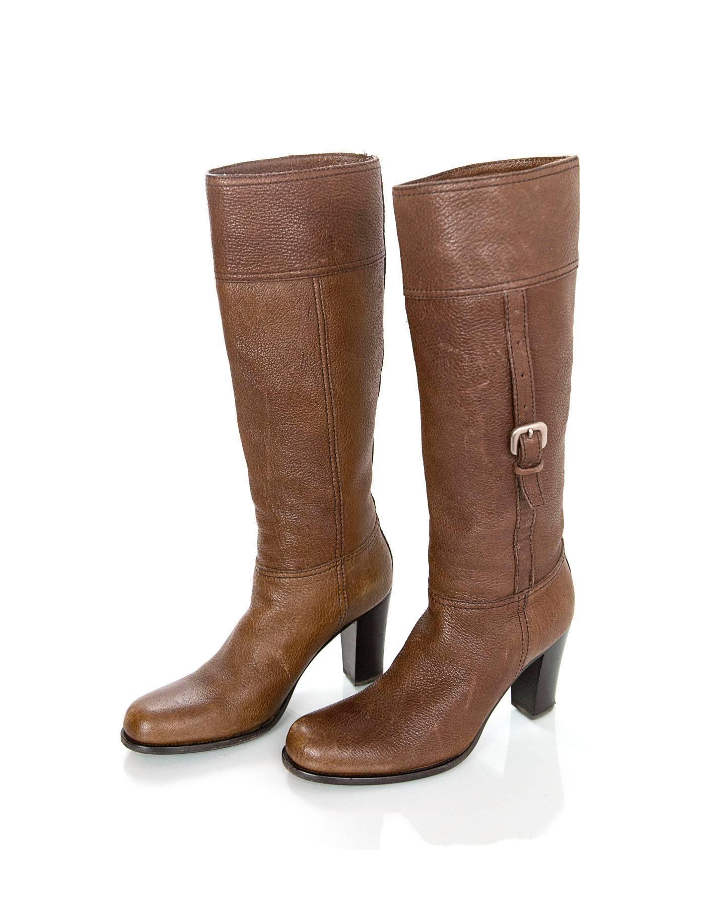 Prada Brown Leather Boots 
Features buckles on sides for cinching shaft

Made In: Italy
Color: Brown
Materials: Leather
Closure/Opening: Pull on
Sole Stamp: Prada Vero Cuoio 36 1/2 Made in Italy 
Overall Condition: Very good pre-owned