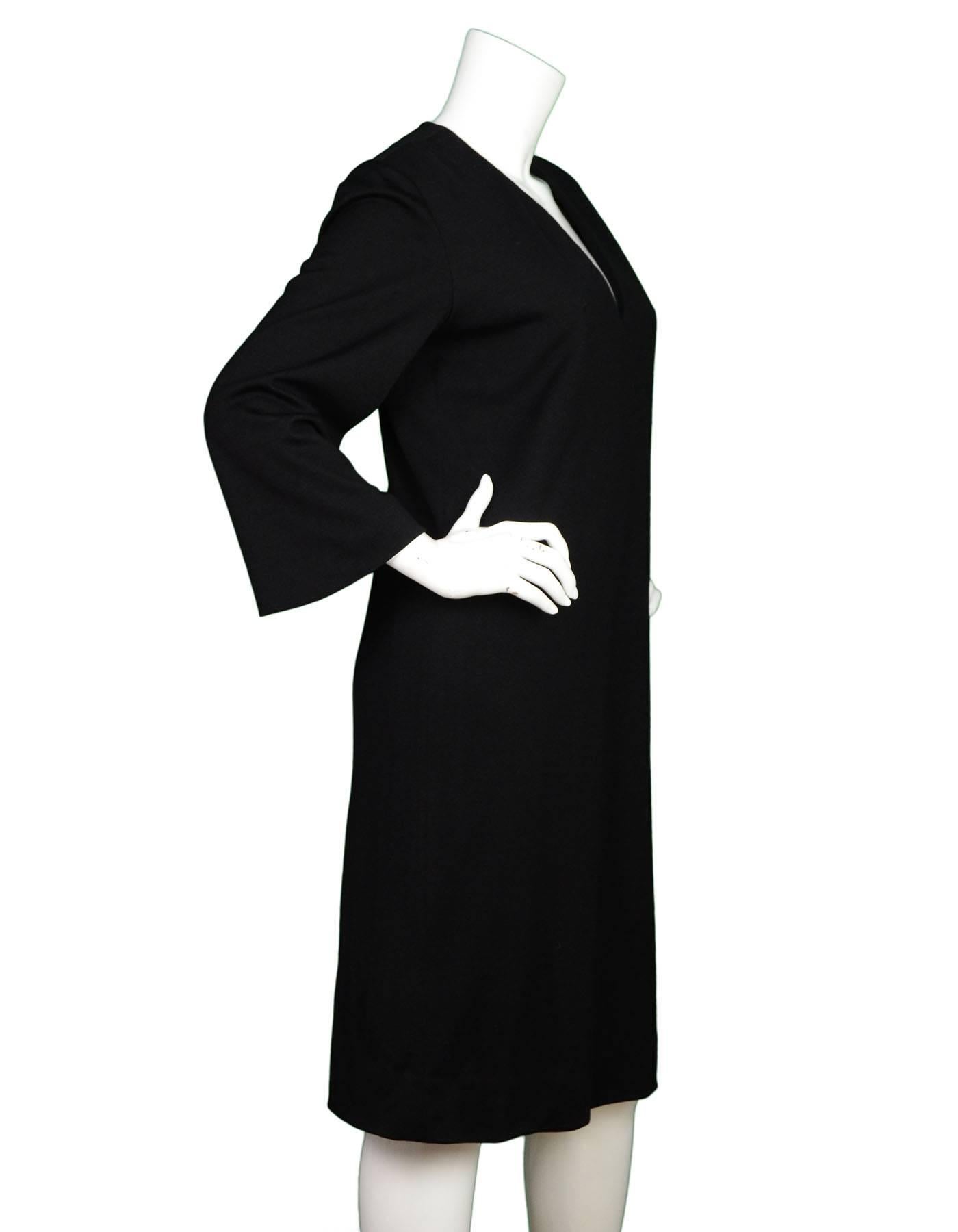 Yves Saint Laurent Black Wool Dress 
Made In: France
Color: Black
Composition: 86% wool, 14% silk
Lining: Black, silk blend
Closure/Opening: Zip up back
Exterior Pockets: None
Interior Pockets: None
Overall Condition: Excellent vintage, pre-owned