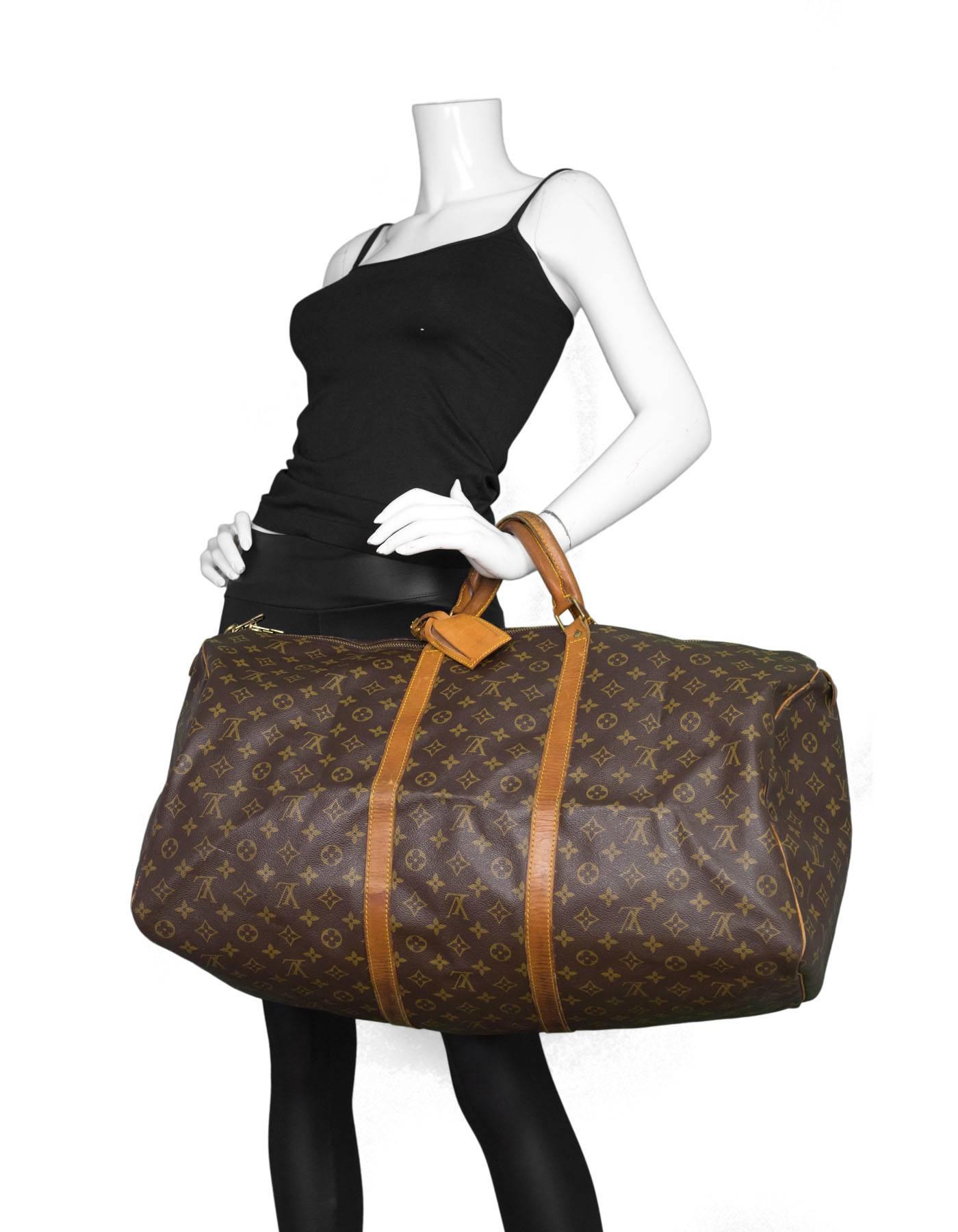 100% Authentic Louis Vuitton Vintage Monogram Keepall 60. Features all-over monogram print with aged tan leather handles and brass hardware. Brown textile interior. Includes lock and luggage tag. Excellent pre-owned condition with the exception of