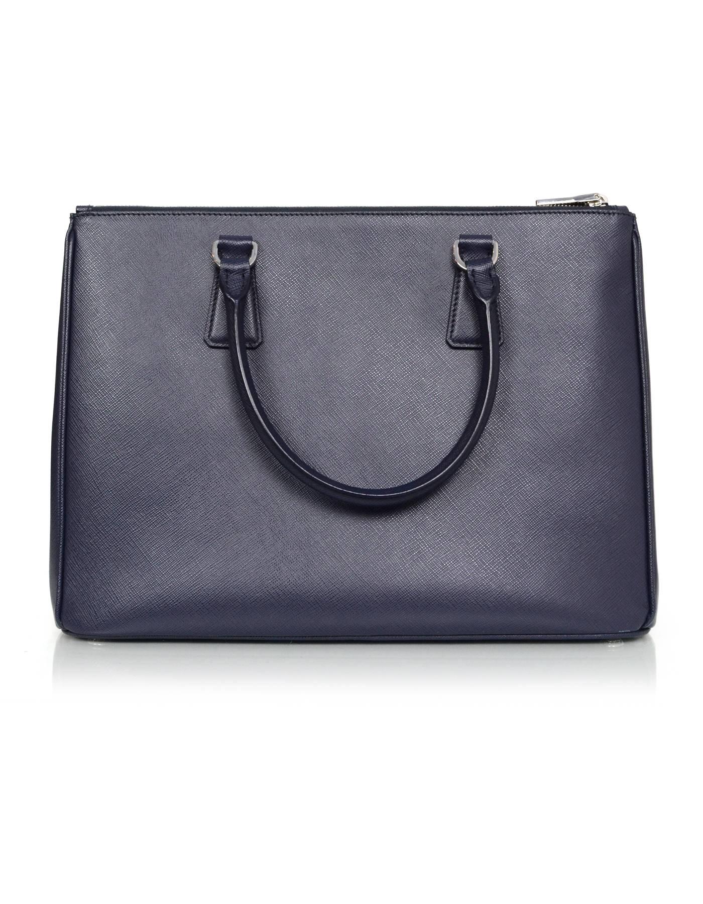 100% Authentic Prada baltico navy saffiano leather 1BA274 medium tote bag. Features double zip compartment and detachable shoulder/crossbody strap

Made In: Italy
Color: Blue blatico
Hardware: Silvertone
Materials: Saffiano textured leather
Lining: