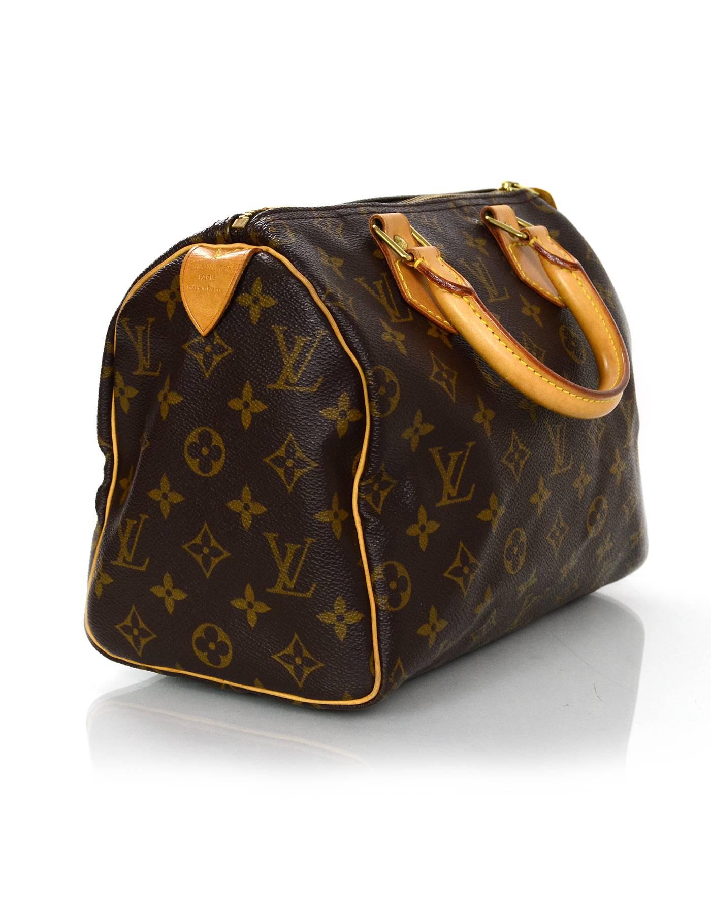 Louis Vuitton Monogram Speedy 25 Bag
Features leather wrapped handles

Made In: France
Year of Production: 1999
Color: Brown
Hardware: Goldtone
Materials: Leather and coated canvas
Lining: Brown canvas
Closure/Opening: Zip across top
Exterior