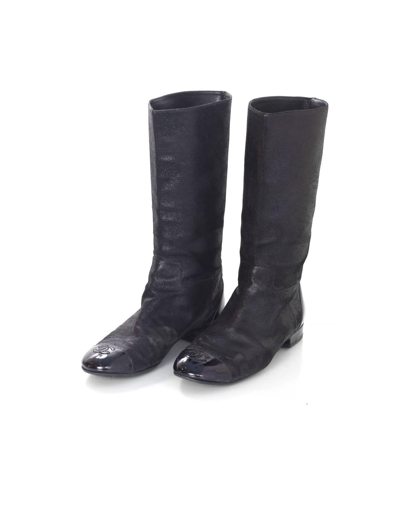 Chanel Black Iridescent Sueded Leather Boots
Features patent toe cap with CC stitched on top

Made In: Italy
Color: Iridescent black
Materials: Sueded leather and patent leather
Closure/Opening: Pull on
Sole Stamp: Made in Italy 38
Overall