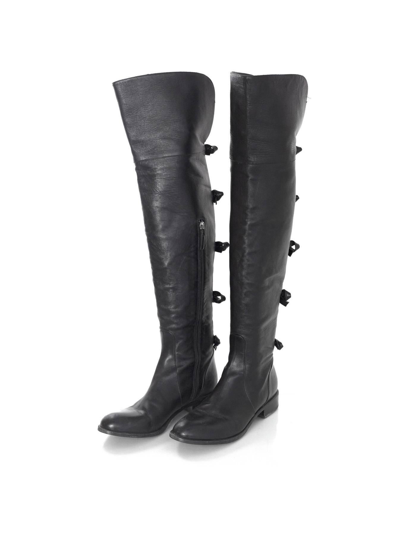 Valentino Black Leather Knee-High Boots 
Features black leather bows going down backs of boots

Made In: Italy
Color: Black
Materials: Leather
Closure/Opening: Pull on with inside zipper
Sole Stamp: Valentino Garavani Made In Italy 40
Retail Price: